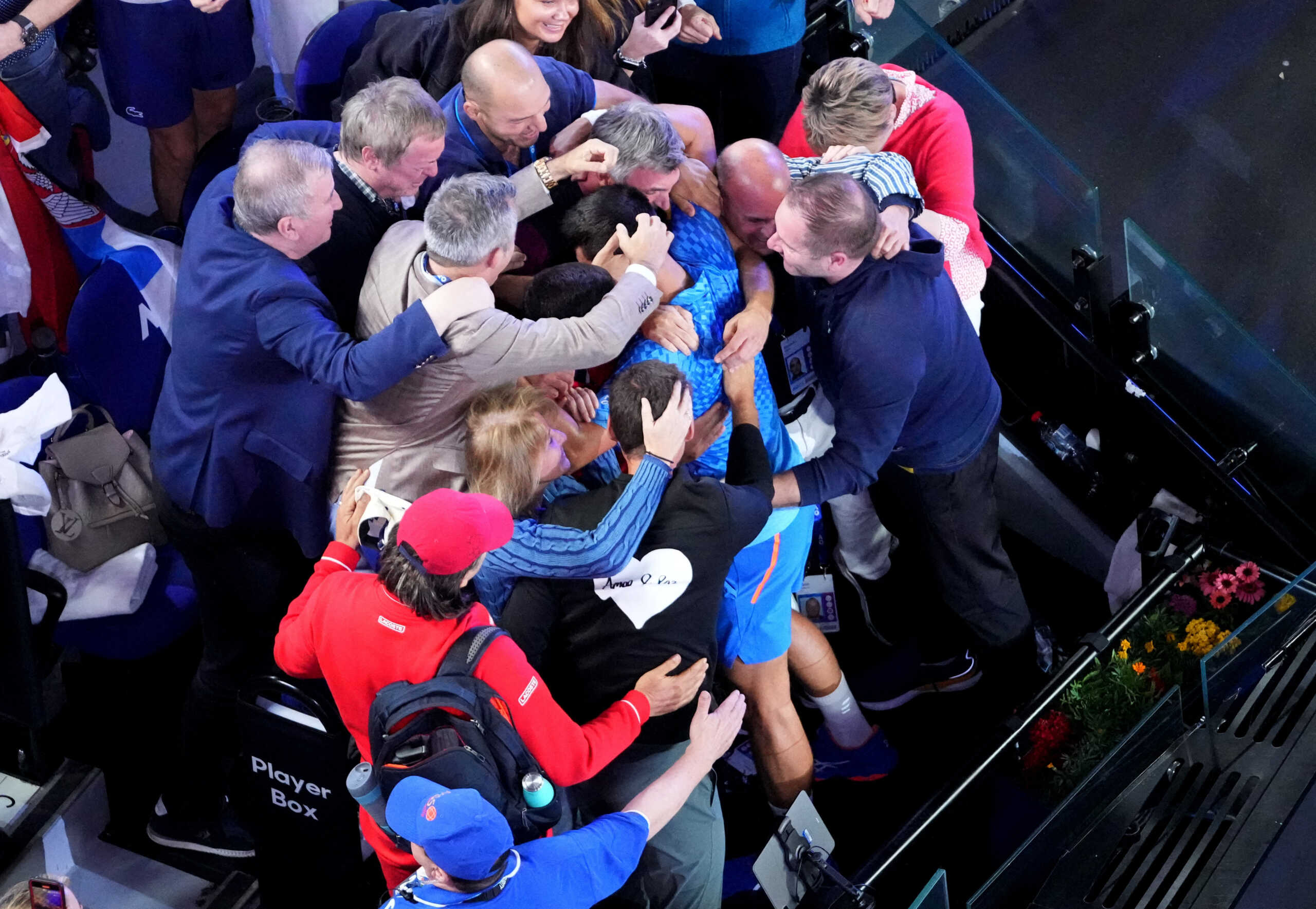 Tennis - Australian Open - Men's Singles Final - Melbourne Park, Melbourne, Australia - January 29, 2023 Serbia's Novak Djokovic celebrates with his mother, Dijana Djokovic, his managers Elena Cappellaro and Edoardo Artaldi, his brother Marko Djokovic and his coach Goran Ivanisevic after winning his final match against Greece's Stefanos Tsitsipas REUTERS