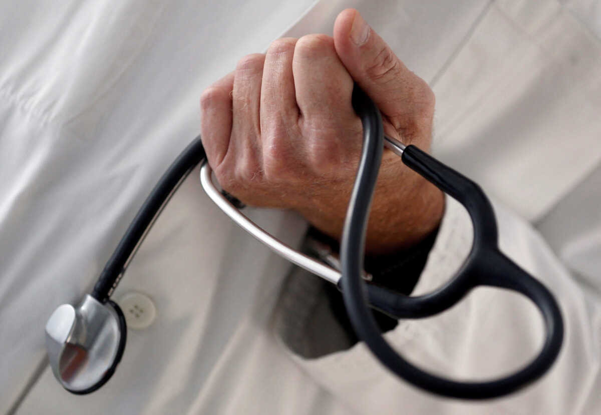 FILE PHOTO: A photo illustration shows a French general practitioner holding a stethoscope in a doctor's office in Bordeaux January 7, 2015. REUTERS