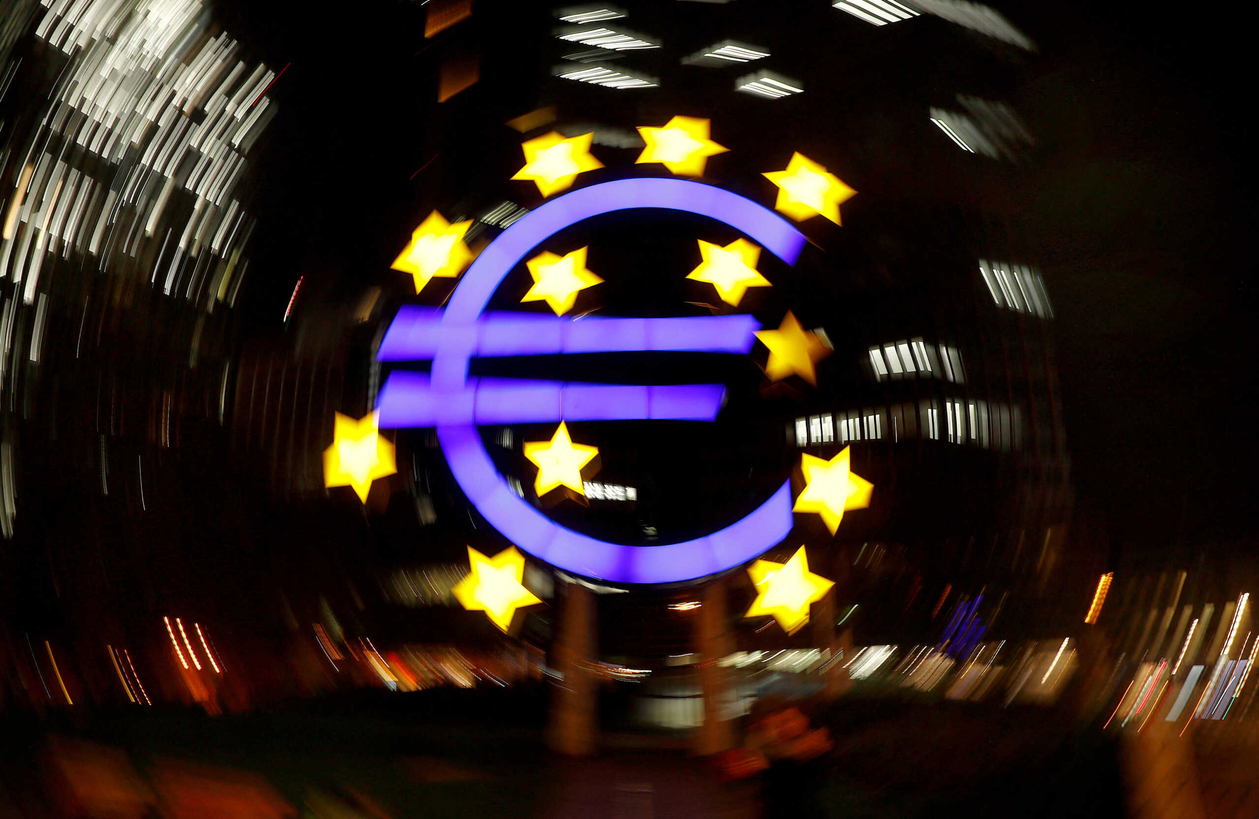 FILE PHOTO: The euro sign is photographed in front of the former head quarter of the European Central Bank in Frankfurt, Germany, April 9, 2019. Picture is taken on slow shutter speed while the camera was moved.  REUTERS
