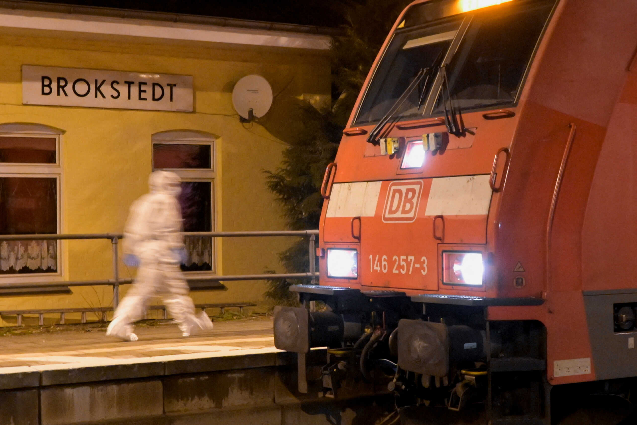 A forensic expert walks next to a train at a railway station after an incident involving a knife attack took place on a train travelling between Kiel and Hamburg, in Brokstedt, Germany, January 25, 2023.   REUTERS