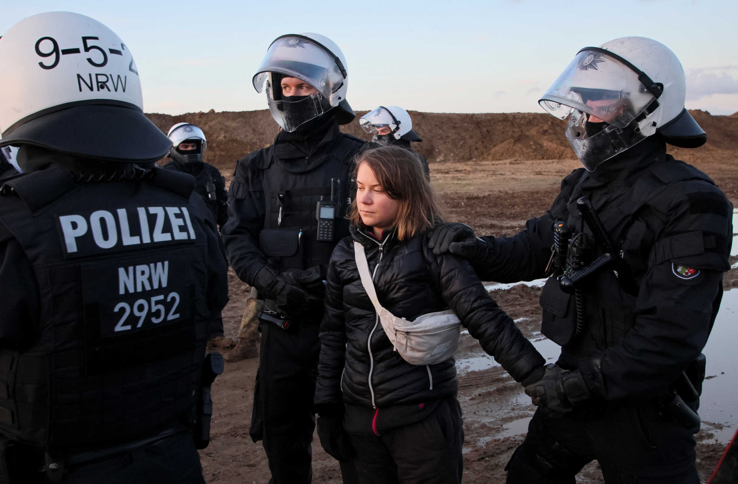 Police officers detain climate activist Greta Thunberg on the day of a protest against the expansion of the Garzweiler open-cast lignite mine of Germany's utility RWE to Luetzerath, in Germany, January 17, 2023 that has highlighted tensions over Germany's climate policy during an energy crisis. REUTERS