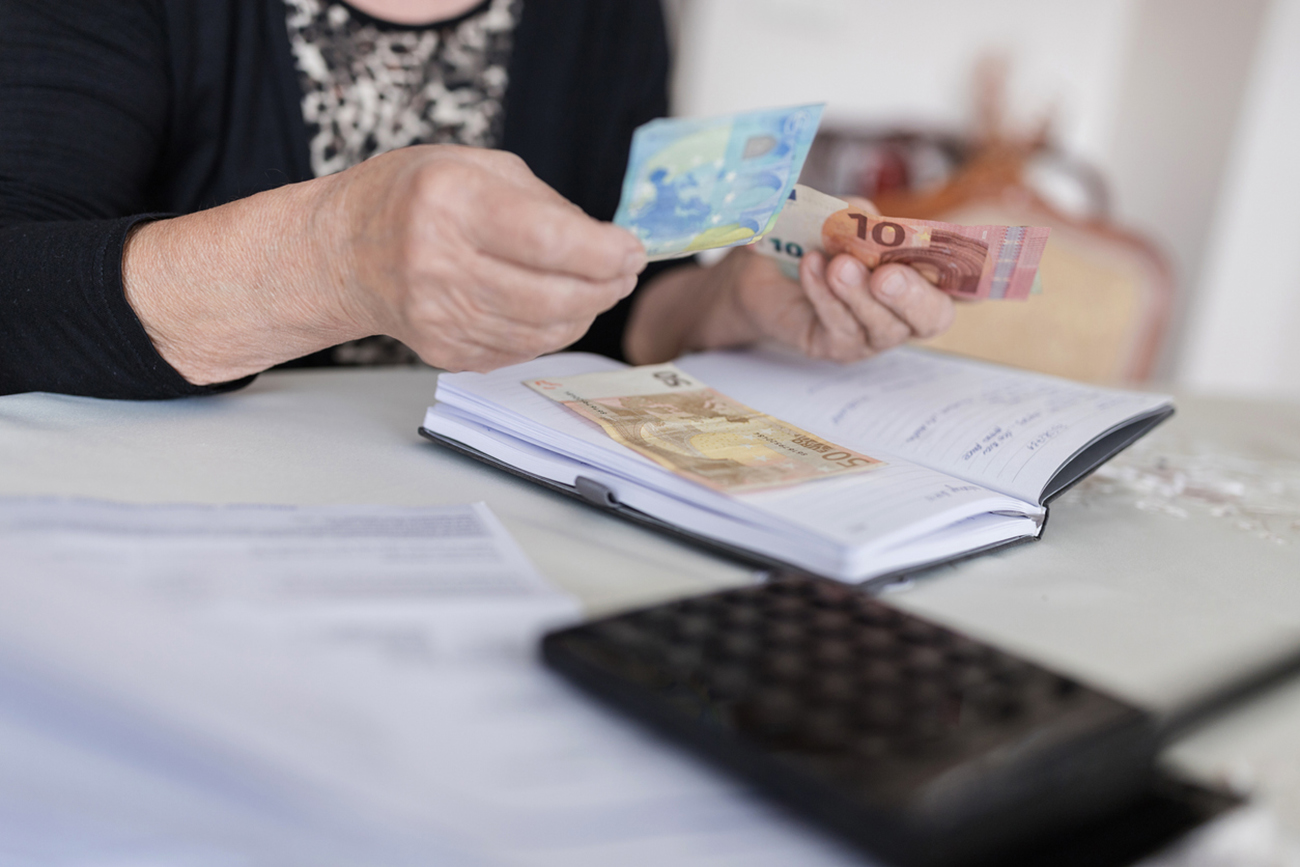 Mature female hands holding money
