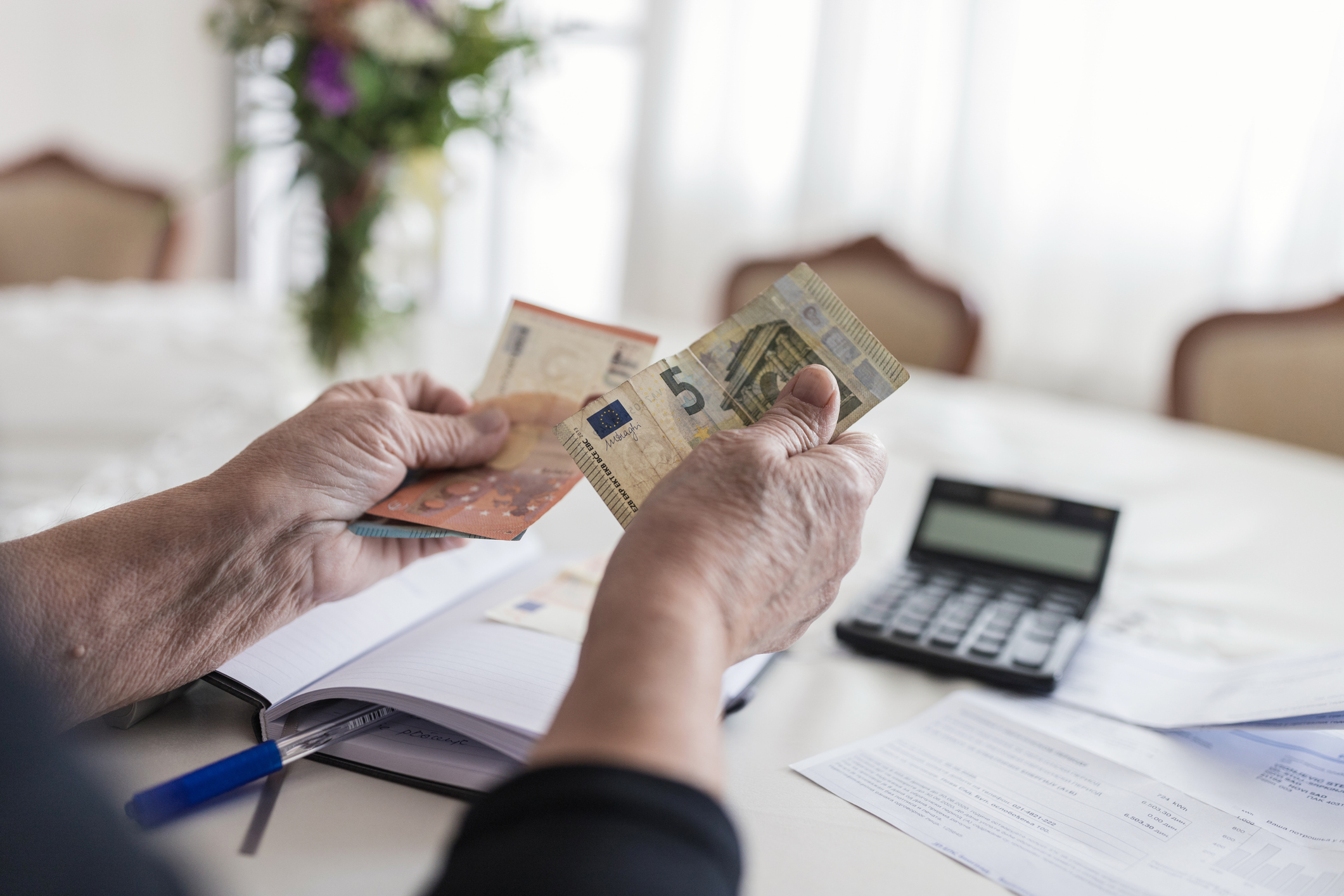 Close-up of unrecognizable senior woman doing finances at home
