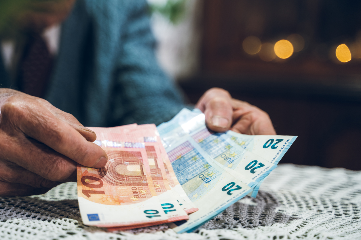 Old man holding europian money.