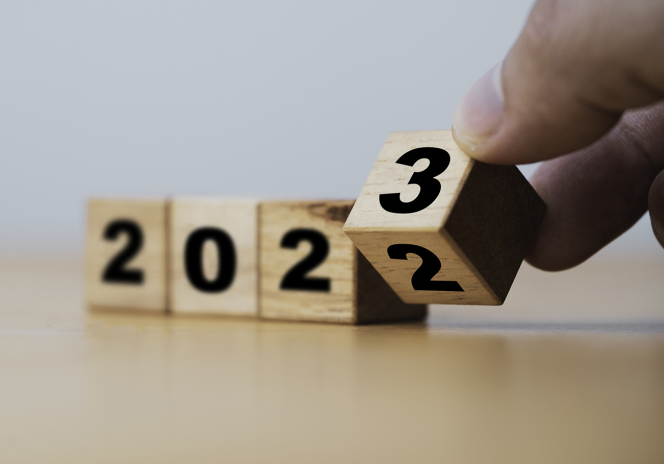 Wooden block cube flipping between 2022 to 2023 for change and preparation merry Christmas and happy new year.