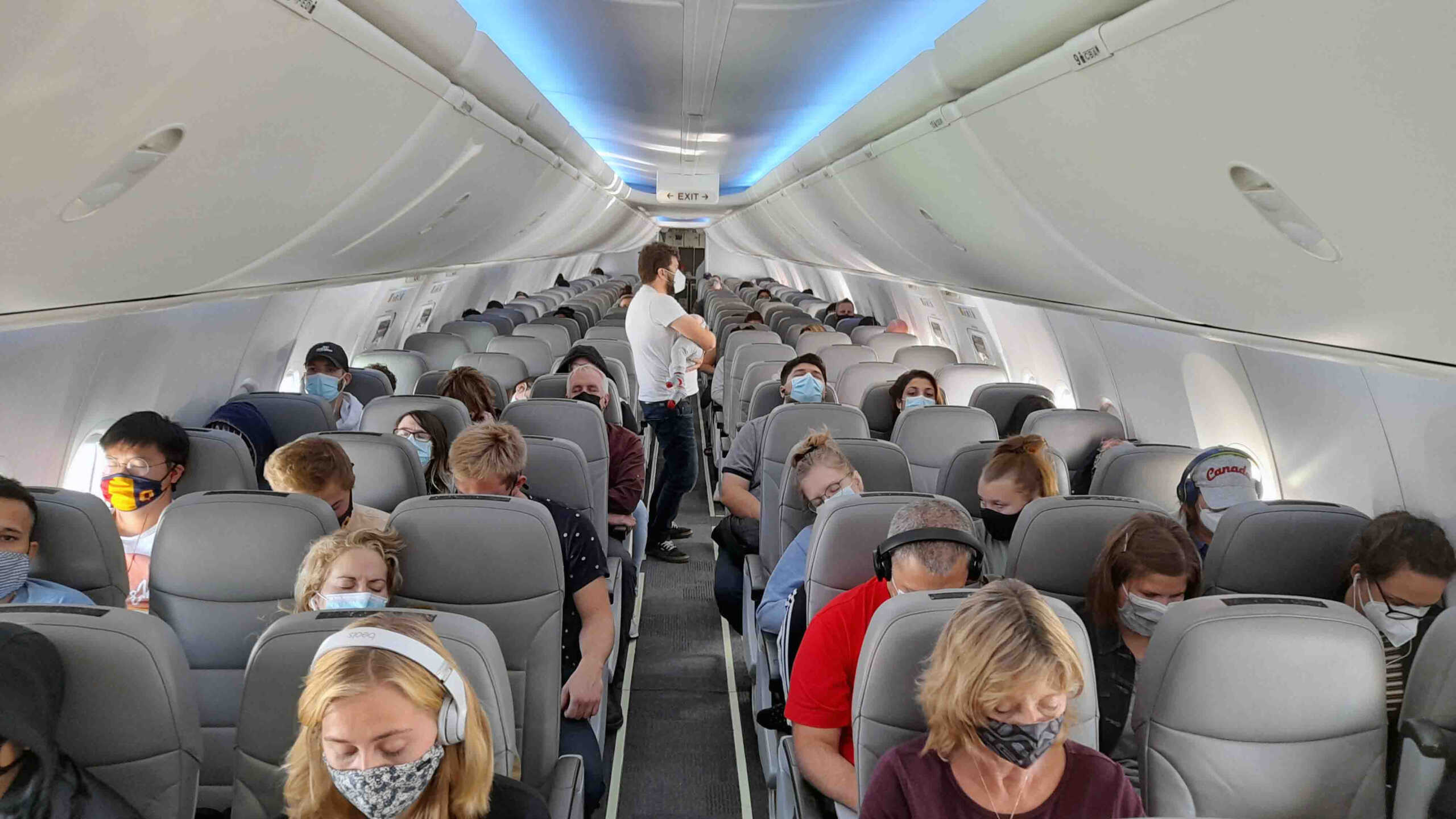 Scene Of People Wearing Non Medical Face Mask Due To COVID-19 Pandemic, Standing, Sitting Down Inside Passengers Airplane In Ottawa Ontario Canada