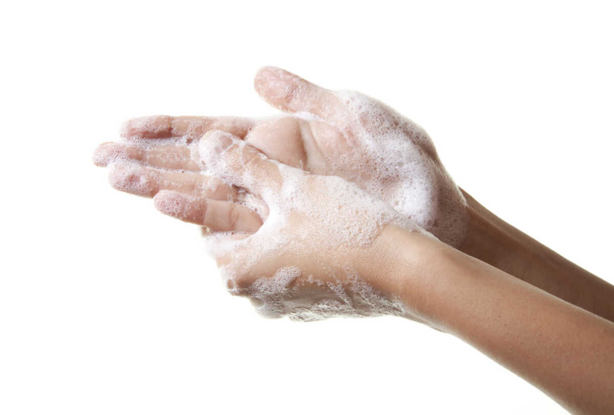A woman washing her hands with a soap suds