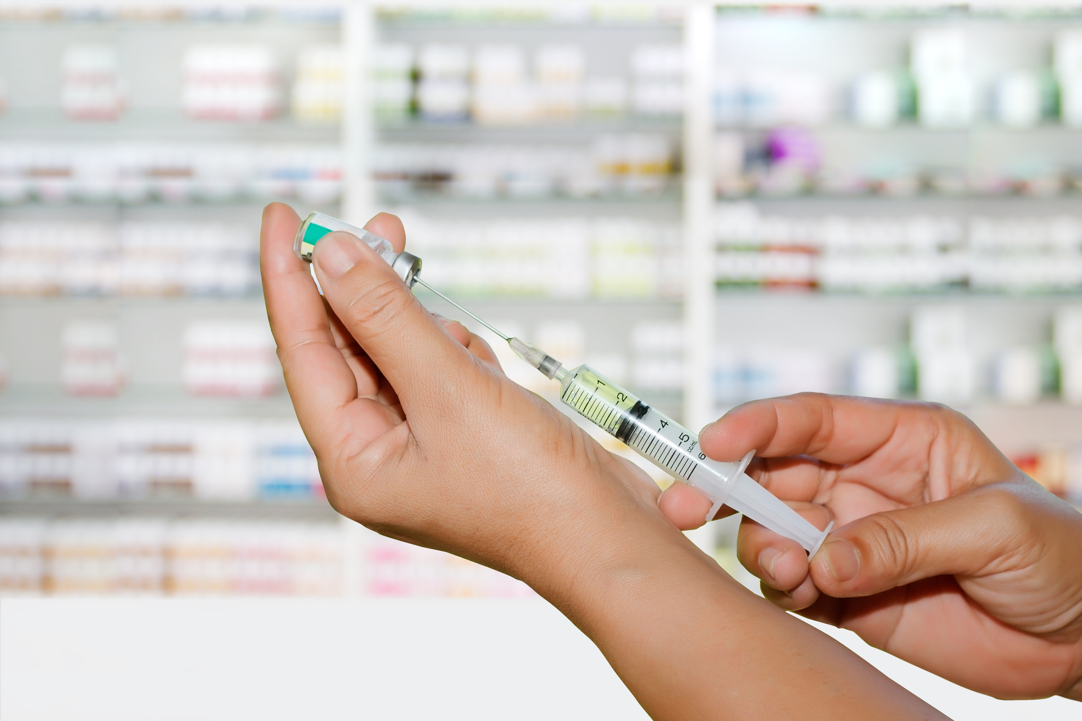 Hands the doctors filling a syringe on store medicine and pharmacy drugstore for background
