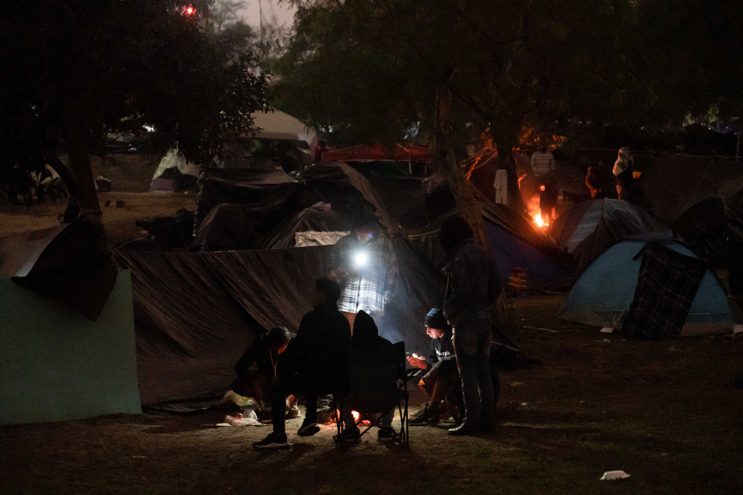Asylum-seeking migrants mostly from Venezuela camp in a park by the Rio Grande river, on the day COVID-era Title 42 U.S. migration restrictions were set to end, until the U.S. Supreme Court ruled to let the policy temporarily stay in place, in Matamoros, Mexico, December 21, 2022.  REUTERS