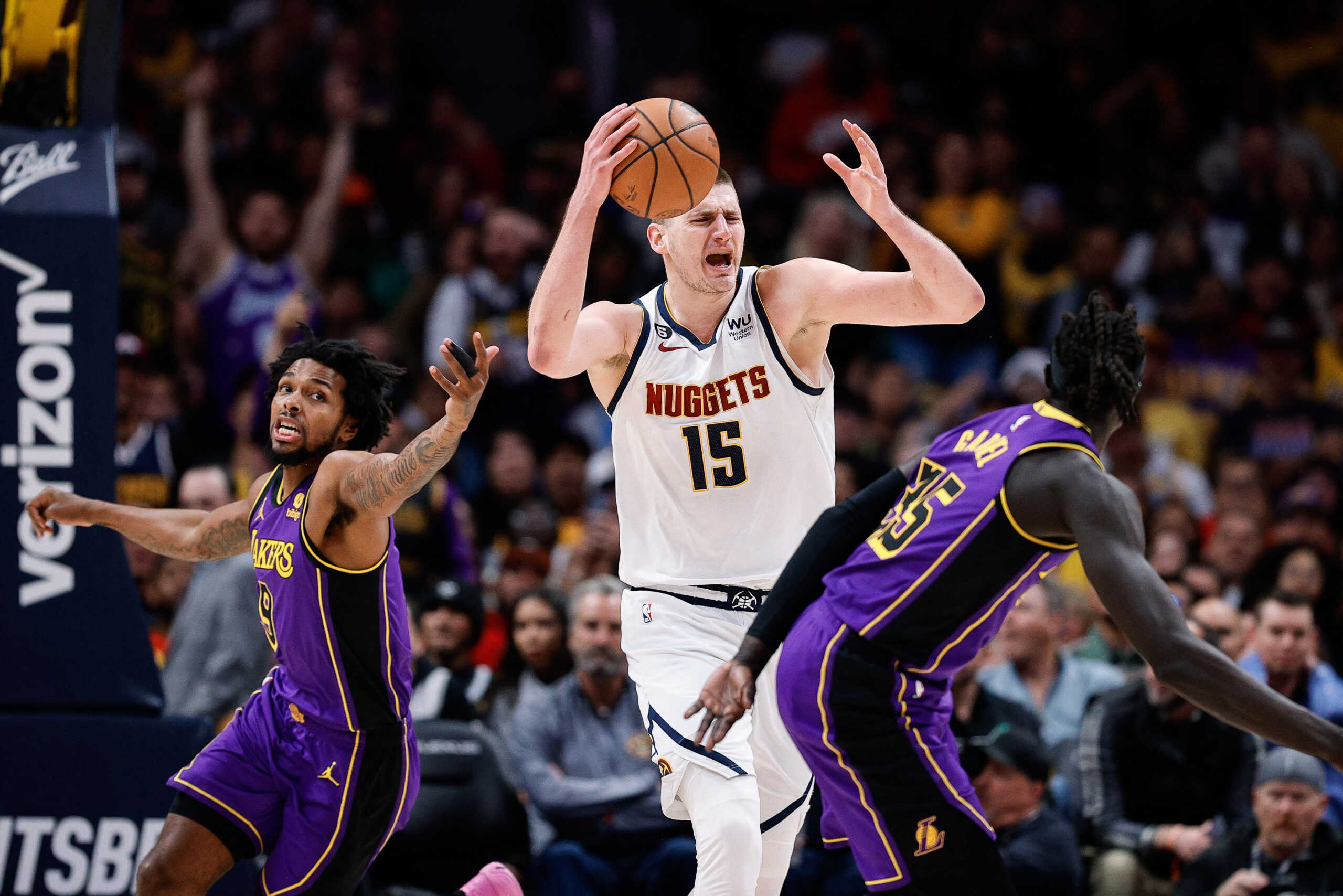 Jan 9, 2023; Denver, Colorado, USA; Denver Nuggets center Nikola Jokic (15) grabs a rebound against Los Angeles Lakers forward Sterling Brown (9) and forward Wenyen Gabriel (35) in the third quarter at Ball Arena. Mandatory Credit: Isaiah J. Downing-USA TODAY Sports