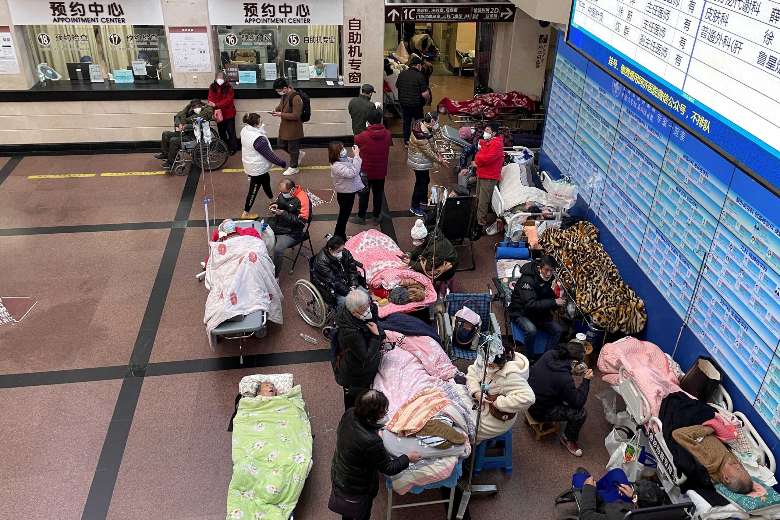 Patients lie on beds and stretchers in a hallway in the emergency department of a hospital, amid the coronavirus disease (COVID-19) outbreak in Shanghai, China January 4, 2023. REUTERS