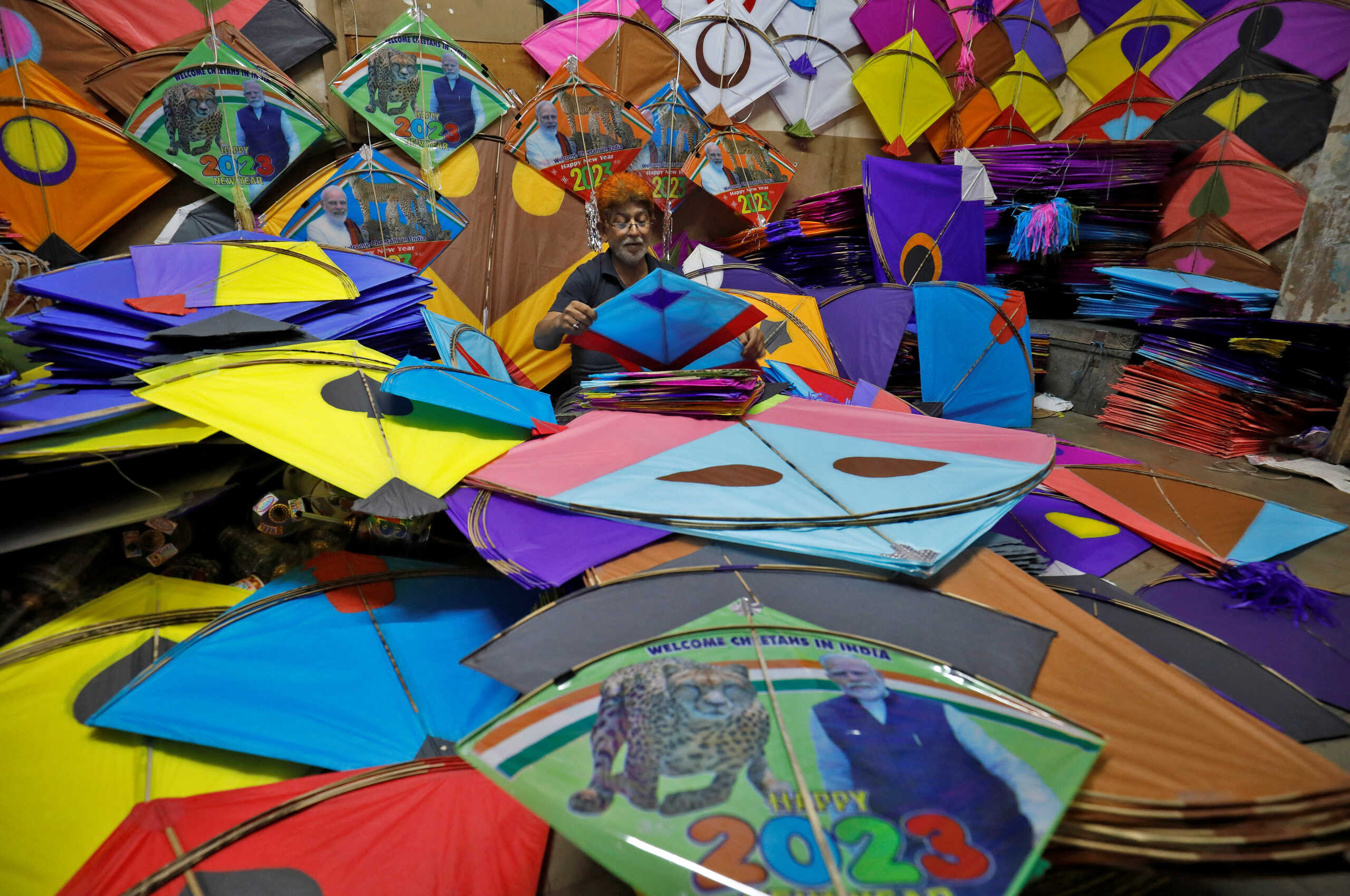 Yunus Belim, 48, a kite maker, checks the quality of a kite before packing it inside a workshop for the upcoming eight-day-long International Kite Festival in Ahmedabad, India, January 3, 2023. REUTERS