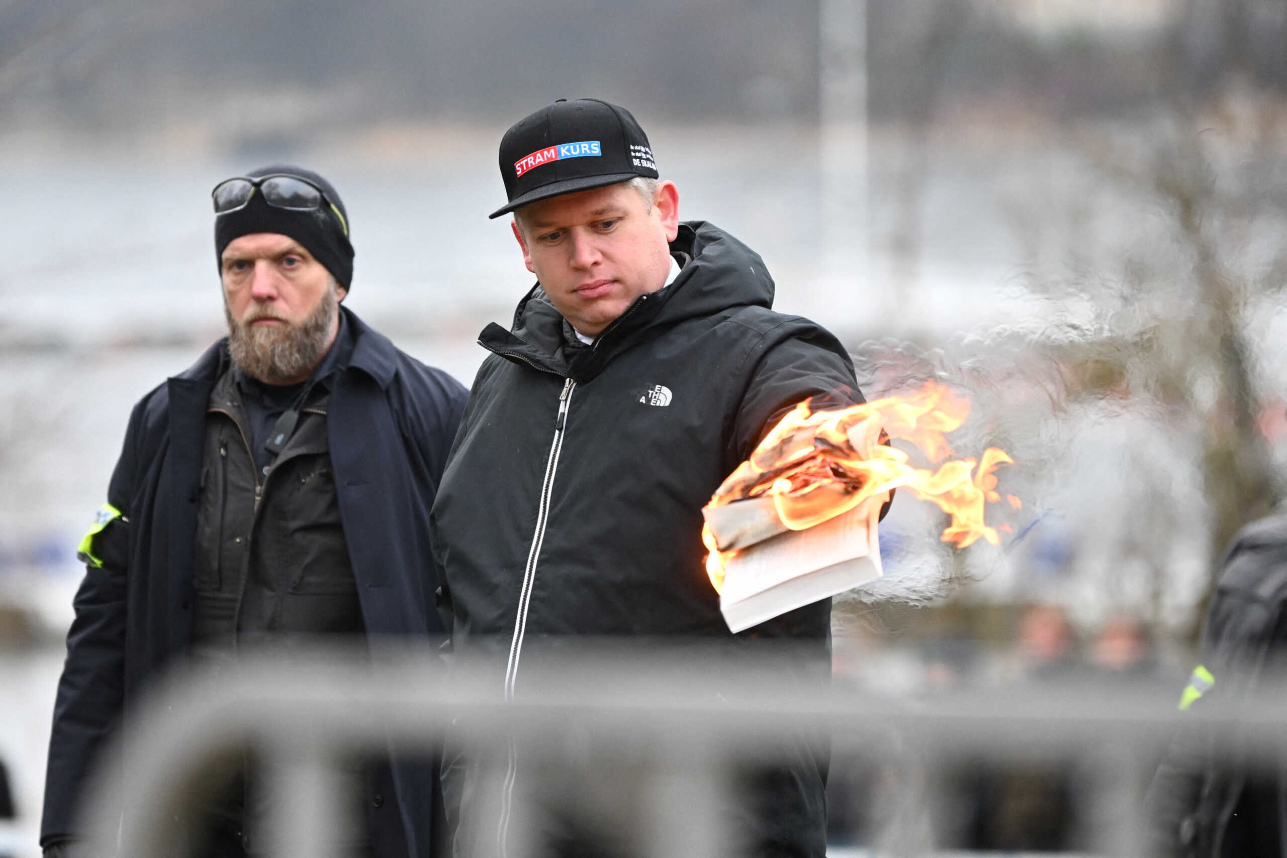 Leader of the far-right Danish political party Stram Kurs Rasmus Paludan burns a copy of the Koran during a manifestation outside the Turkish embassy in Stockholm, Sweden,  January 21, 2023. Fredrik Sandberg