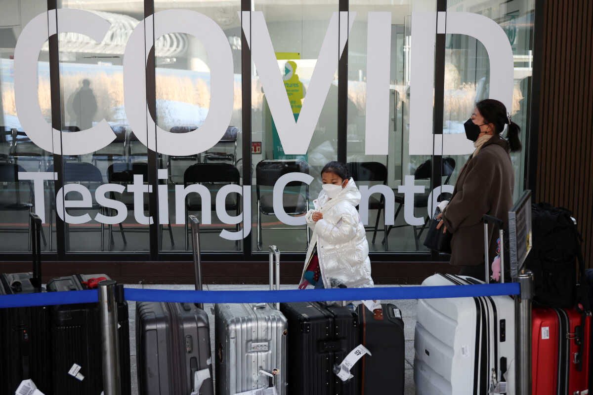 A Chinese girl looks at luggages, standing outside coronavirus disease (COVID-19) testing centre upon her arrival at the Incheon International Airport in Incheon, South Korea, January 4, 2023.   REUTERS