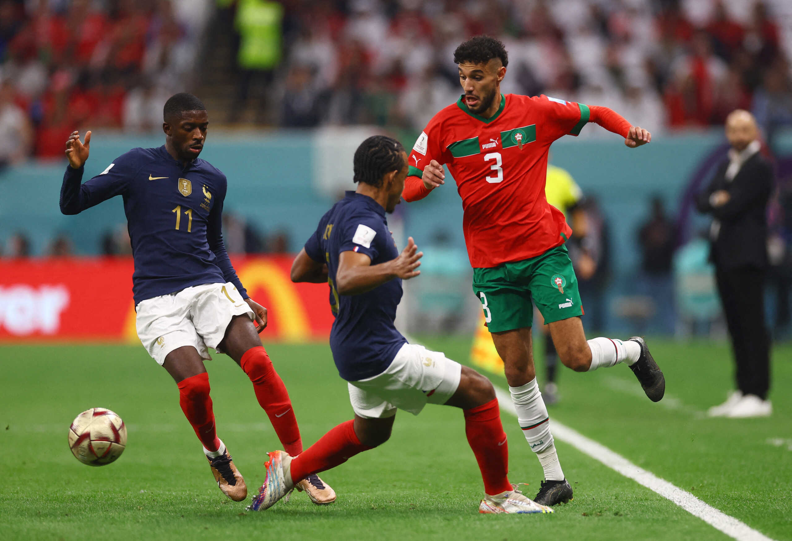 Soccer Football - FIFA World Cup Qatar 2022 - Semi Final - France v Morocco - Al Bayt Stadium, Al Khor, Qatar - December 14, 2022 Morocco's Noussair Mazraoui in action with France's Jules Kounde and Ousmane Dembele REUTERS