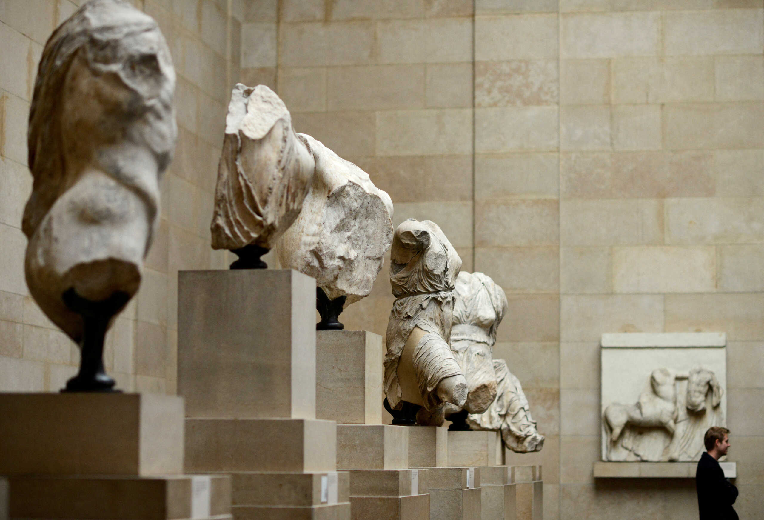 FILE PHOTO: A man looks at the Parthenon Marbles, a collection of stone objects, inscriptions and sculptures, also known as the Elgin Marbles, on show at the British Museum in London October 16, 2014. REUTERS