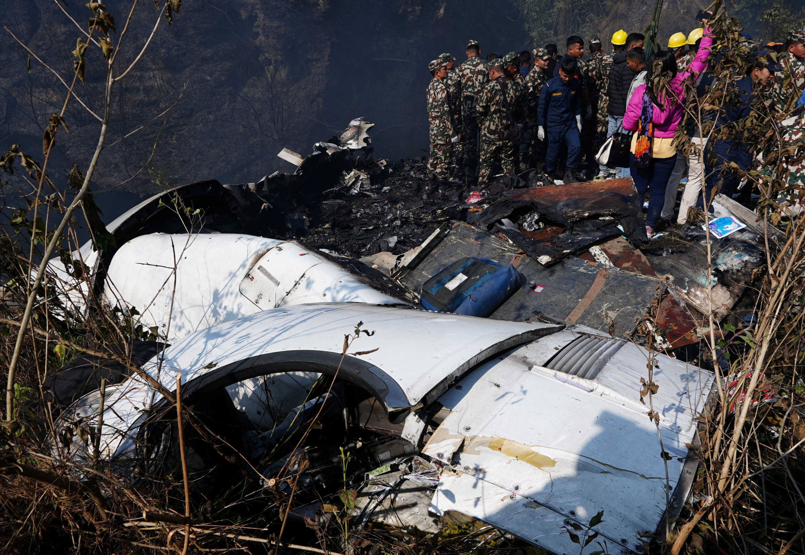 Rescue teams work to retrieve bodies from the wreckage at the crash site of an aircraft carrying 72 people in Pokhara in western Nepal January 15, 2023. REUTERS