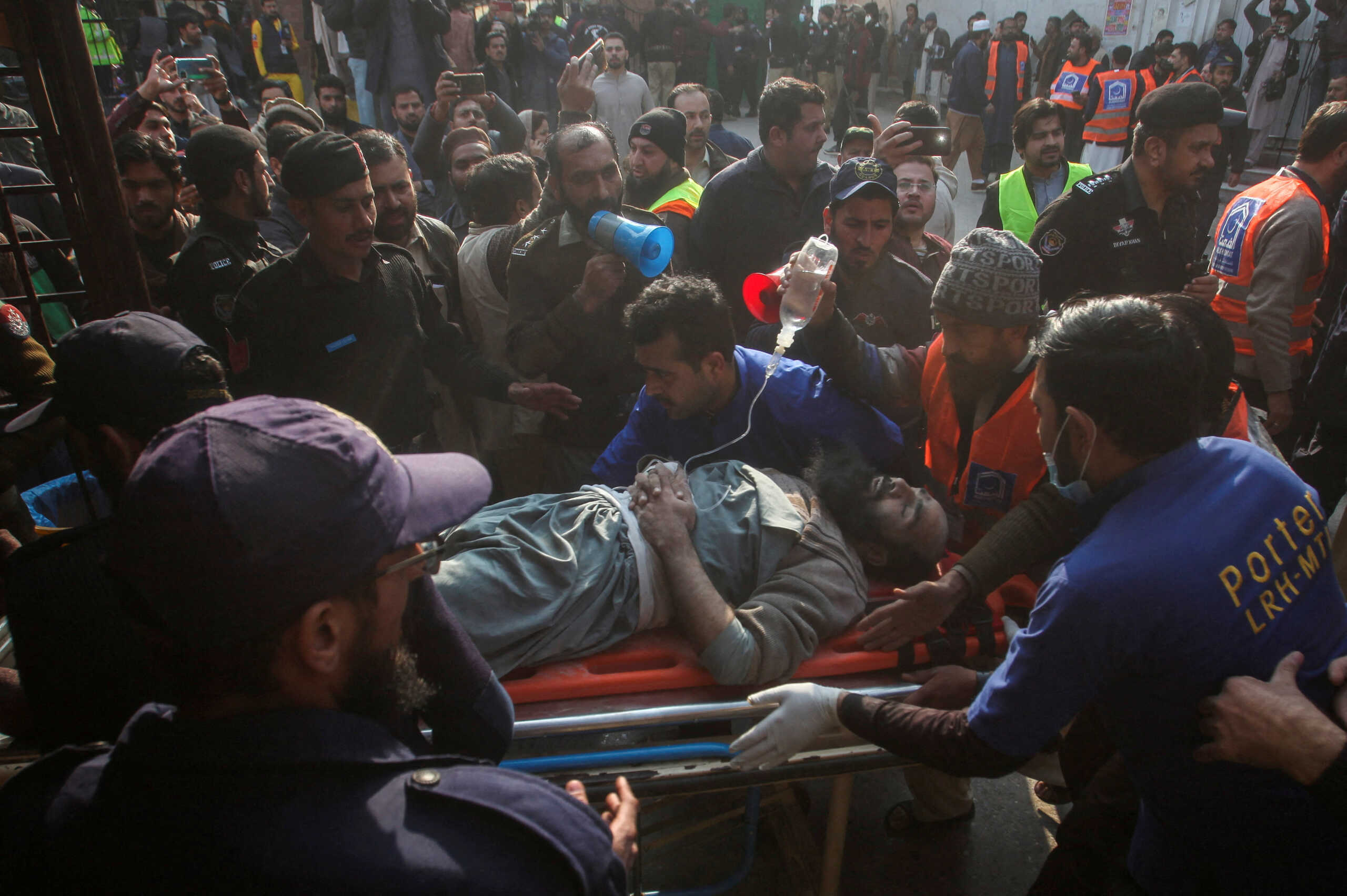 Men move an injured victim, after a suicide blast in a mosque, at hospital premises in Peshawar, Pakistan, January 30, 2023. REUTERS
