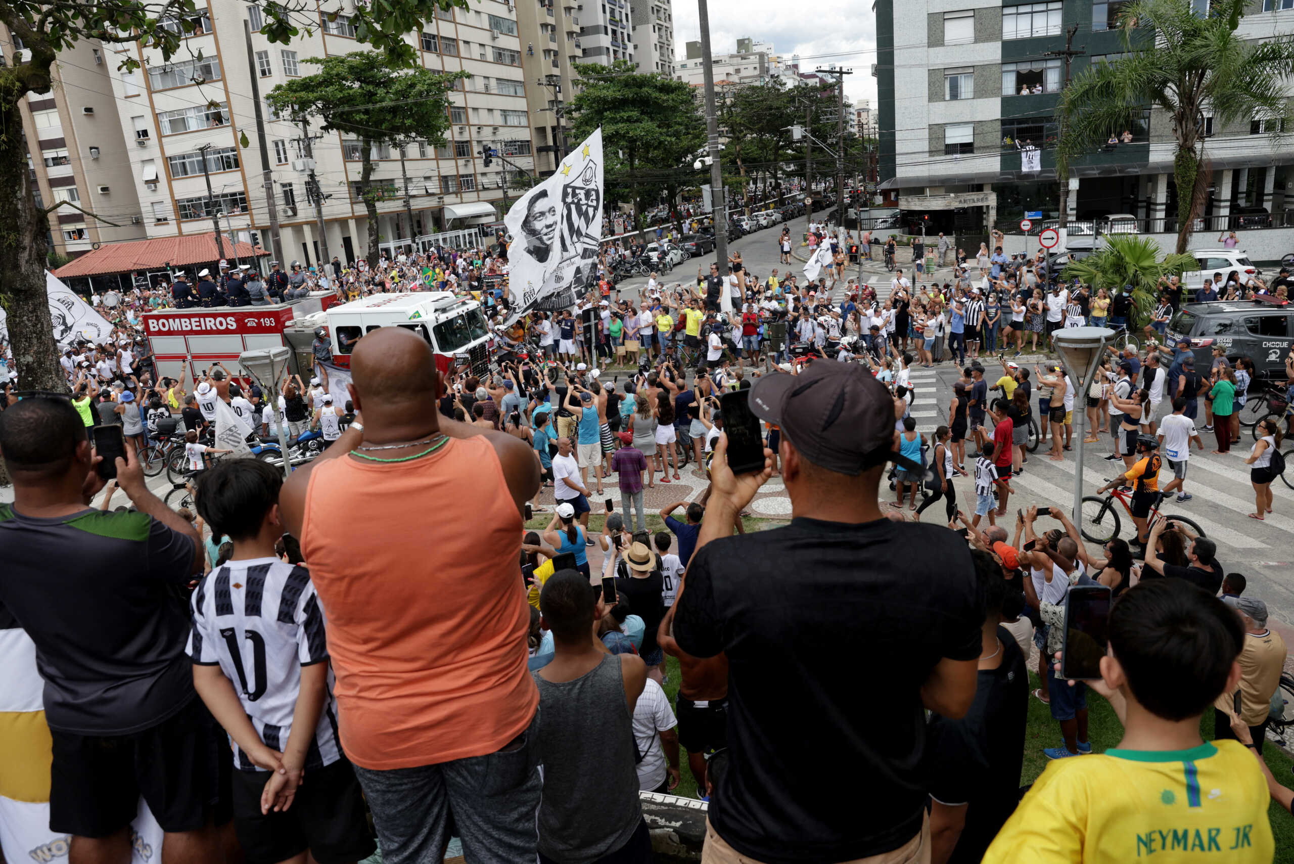 Soccer Football - Death of Brazilian soccer legend Pele - Vila Belmiro Stadium, Santos, Brazil - January 3, 2023 General view of fans as the casket of Brazilian soccer legend Pele is transported by the fire department, from his former club Santos' Vila Belmiro stadium REUTERS