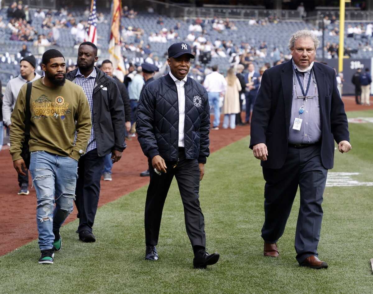 epa09879613 President of the New York Yankees Randy Levine (R) and New York City Mayor Eric Adams (C) walk on the field before the MLB baseball game between the Boston Red Sox and the New York Yankees on Opening Day at Yankee Stadium in the Bronx, New York, USA, 08 April 2022.  EPA