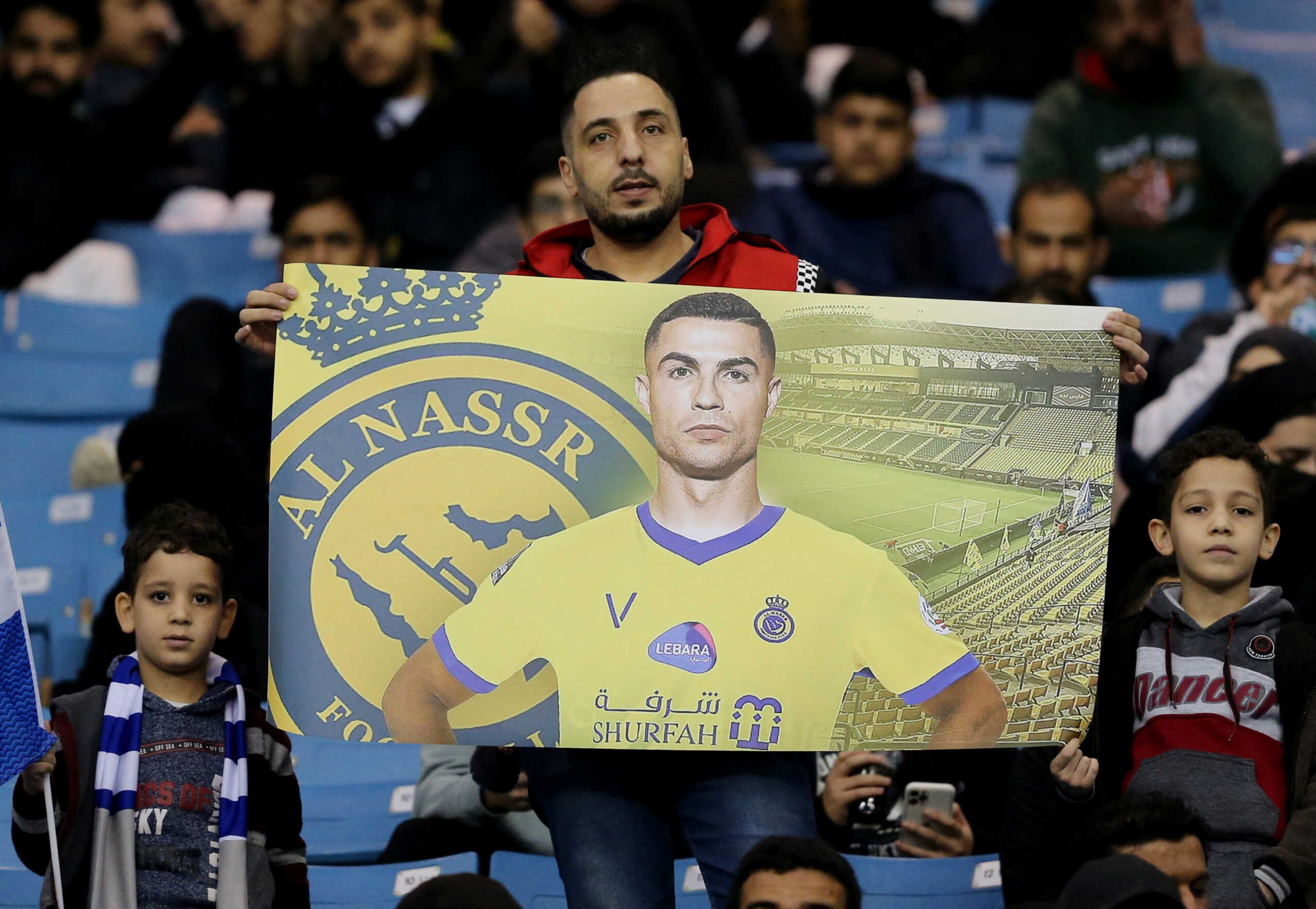 Soccer Football - Friendly - Saudi Pro League XI v Paris St Germain - King Fahd International Stadium, Riyadh, Saudia Arabia - January 19, 2023 A fan holds up a banner of Al Nassr's Cristiano Ronaldo inside the stadium before the match REUTERS