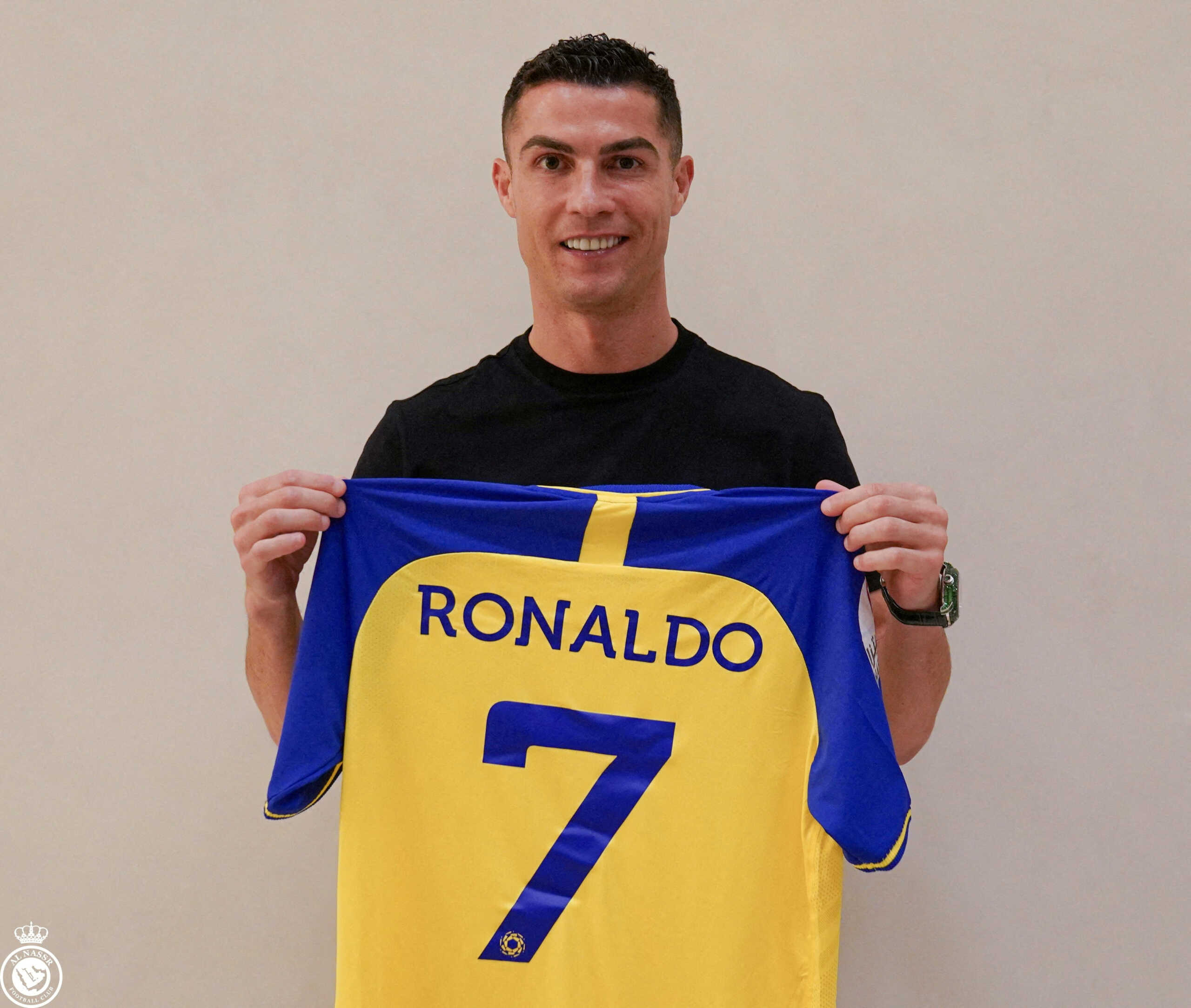 Portuguese soccer player Cristiano Ronaldo holds a shirt of the Saudi Arabian club Al-Nassr after signing the contract that runs until 2025 in this undated handout photo in an unknown location. AL-NASSR FC