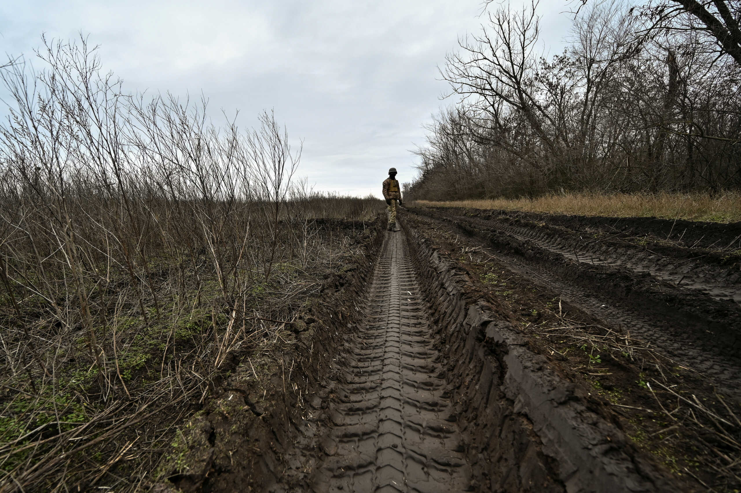 A Ukrainian serviceman stands in a deep truck path on a soil near a position in a frontline, amid Russia's attack on Ukraine, in Zaporizhzhia region, Ukraine January 5, 2023. REUTERS