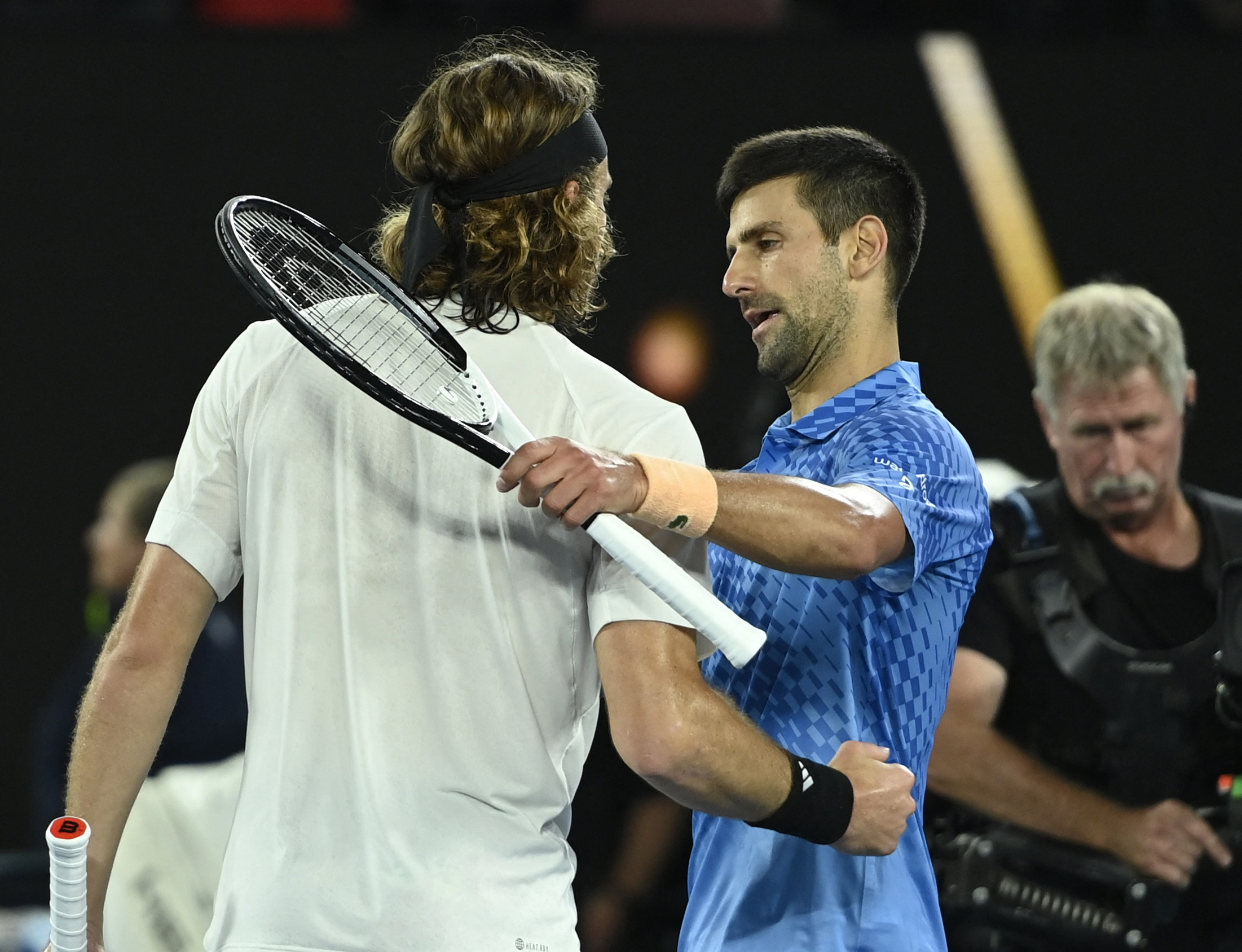 Tennis - Australian Open - Men's Singles Final - Melbourne Park, Melbourne, Australia - January 29, 2023 Serbia's Novak Djokovic hugs Greece's Stefanos Tsitsipas after winning their final match REUTERS