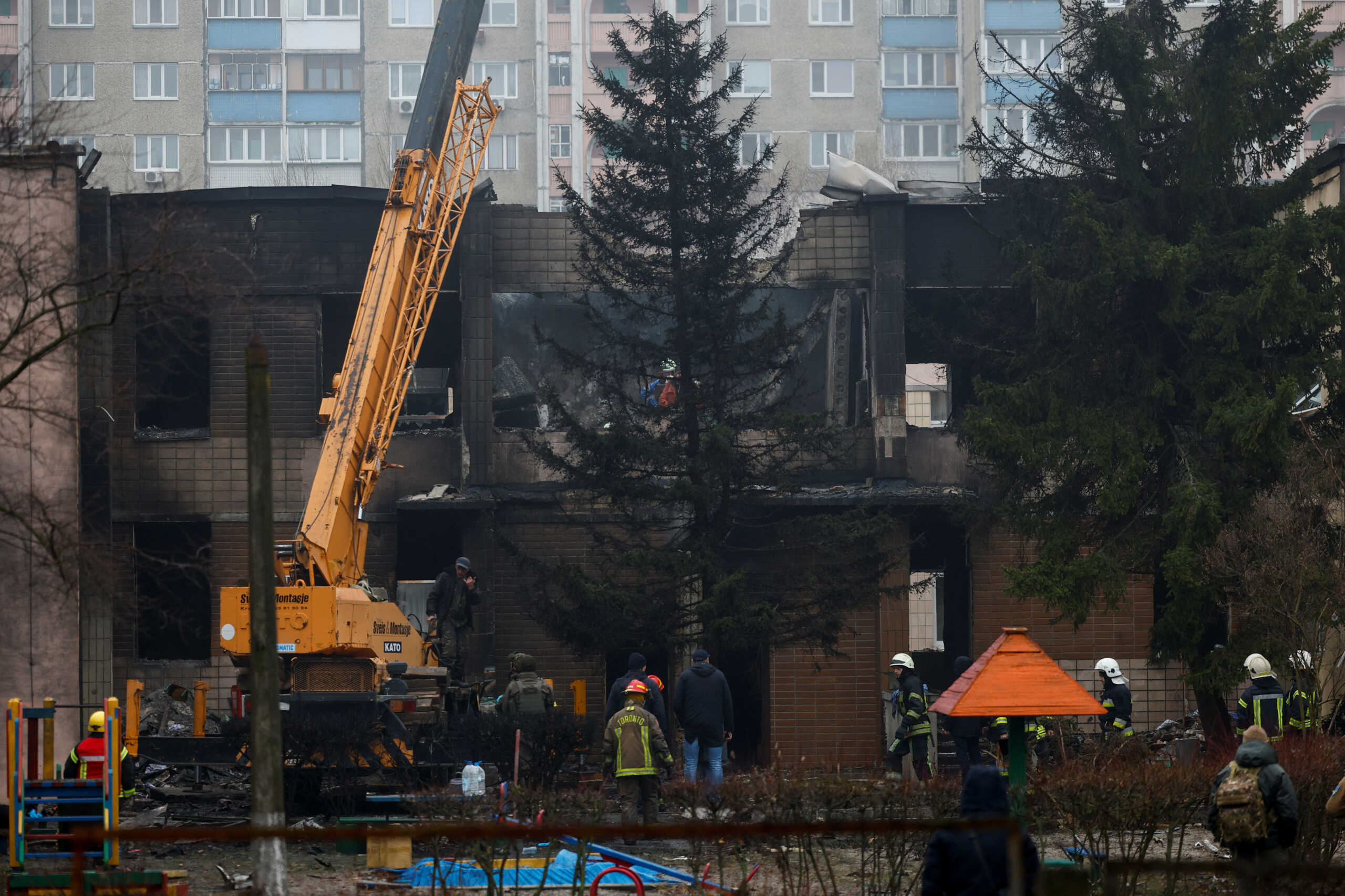 Emergency personnel work at the site of a helicopter crash, amid Russia's attack on Ukraine, in the town of Brovary, outside Kyiv, Ukraine, January 18, 2023. REUTERS