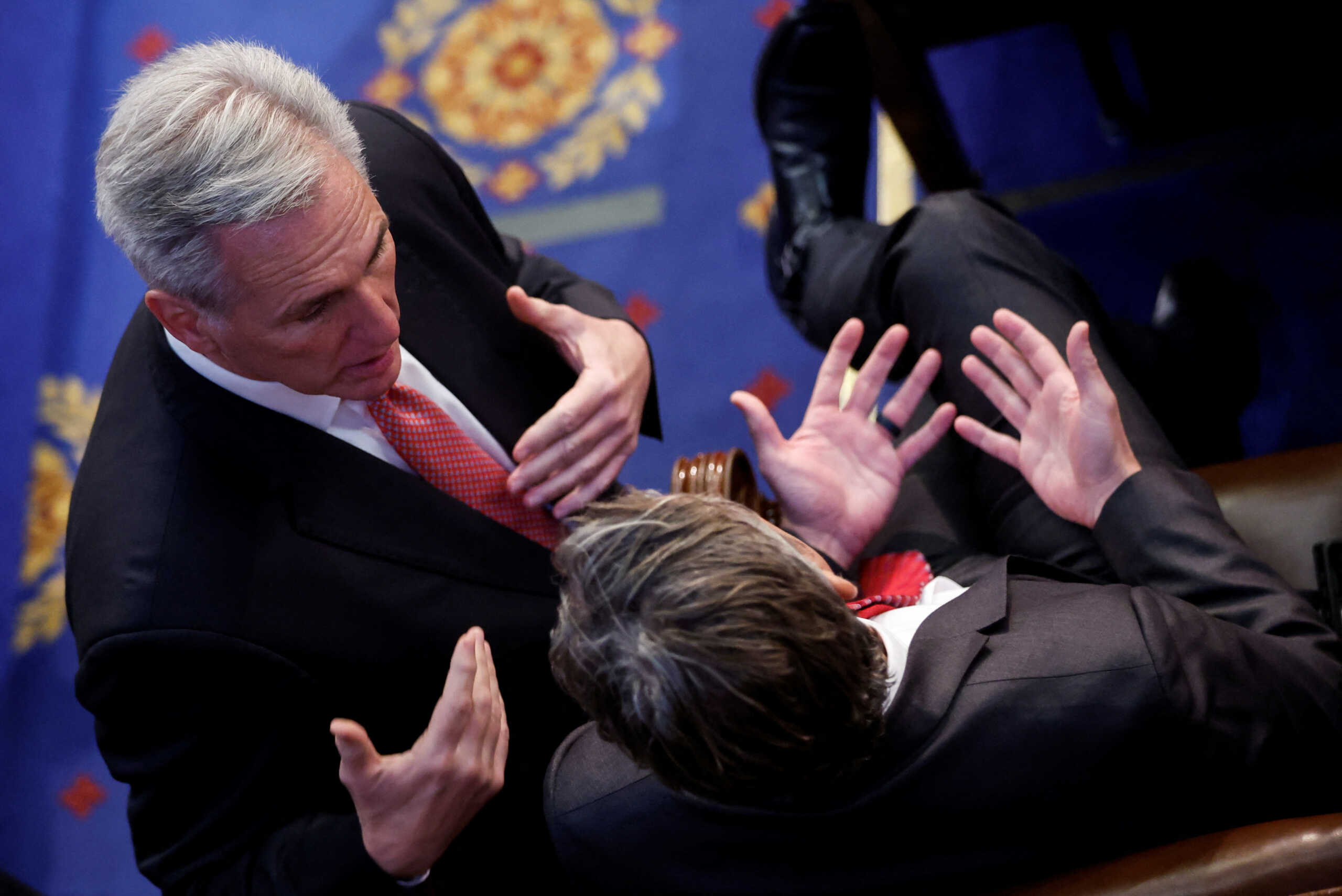 House Republican Leader Kevin McCarthy (R-CA) speaks to U.S. Rep. Andy Ogles (R-TN) inside the House Chamber during voting for a new Speaker on the third day of the 118th Congress at the U.S. Capitol in Washington, U.S., January 5, 2023. REUTERS