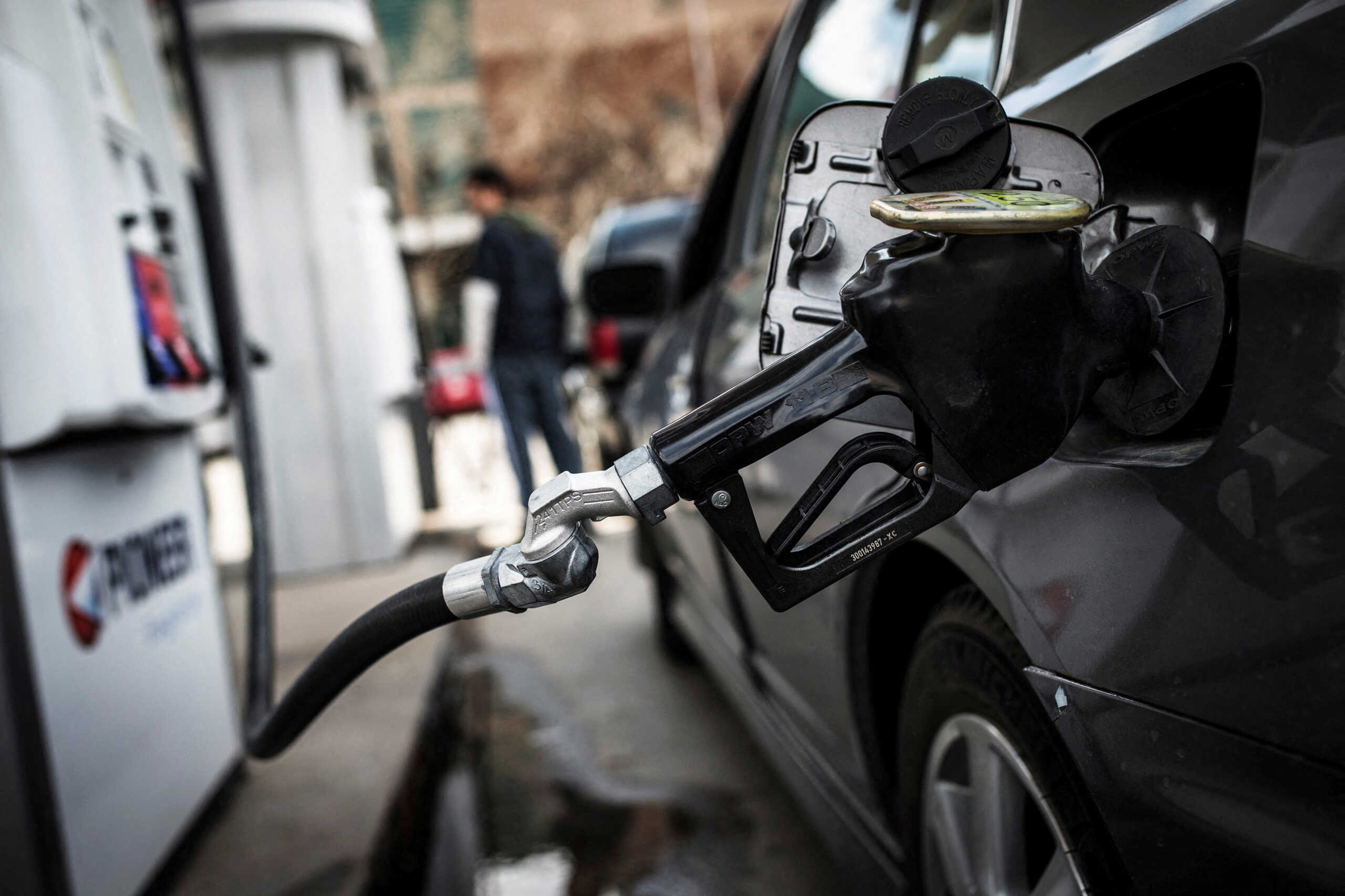 FILE PHOTO: A fuel pump is seen in a car at a gas station in Toronto April 22, 2014. REUTERS