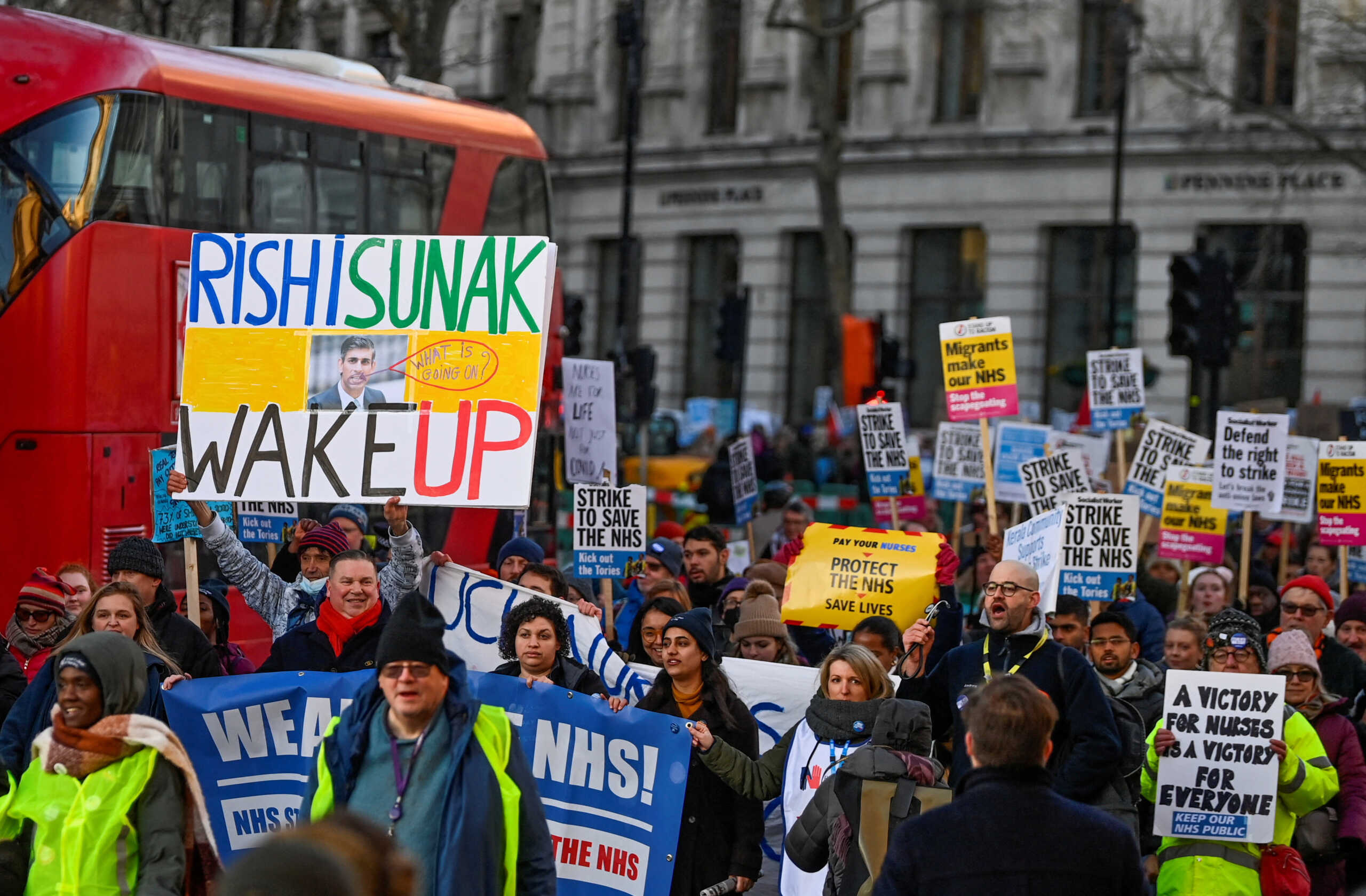 FILE PHOTO: People hold placards during a strike by NHS nurses and other medical workers, amid a dispute with the government over pay, in London, Britain, January 18, 2023. REUTERS