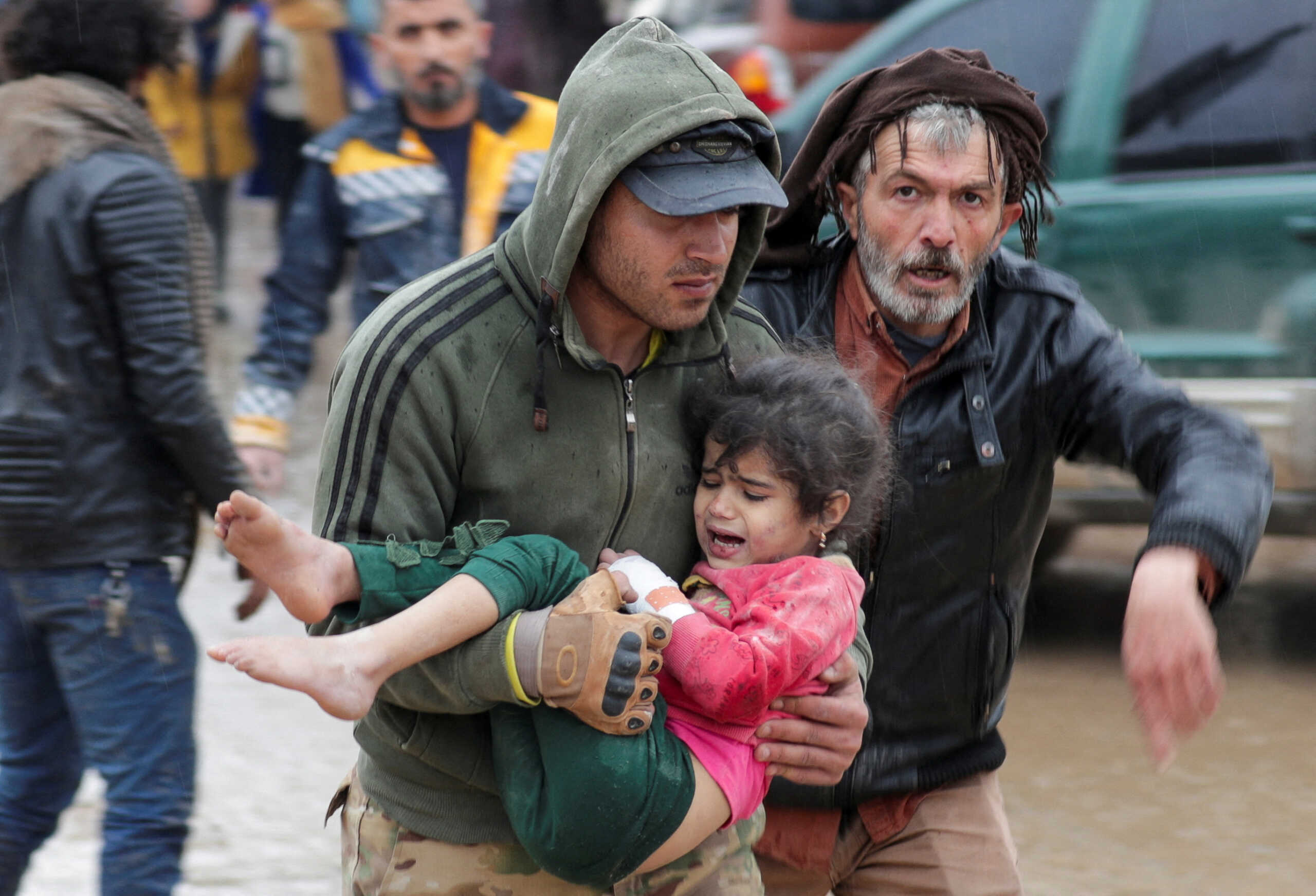 A man carries a girl following an earthquake, in rebel-held town of Jandaris, Syria February 6, 2023. REUTERS
