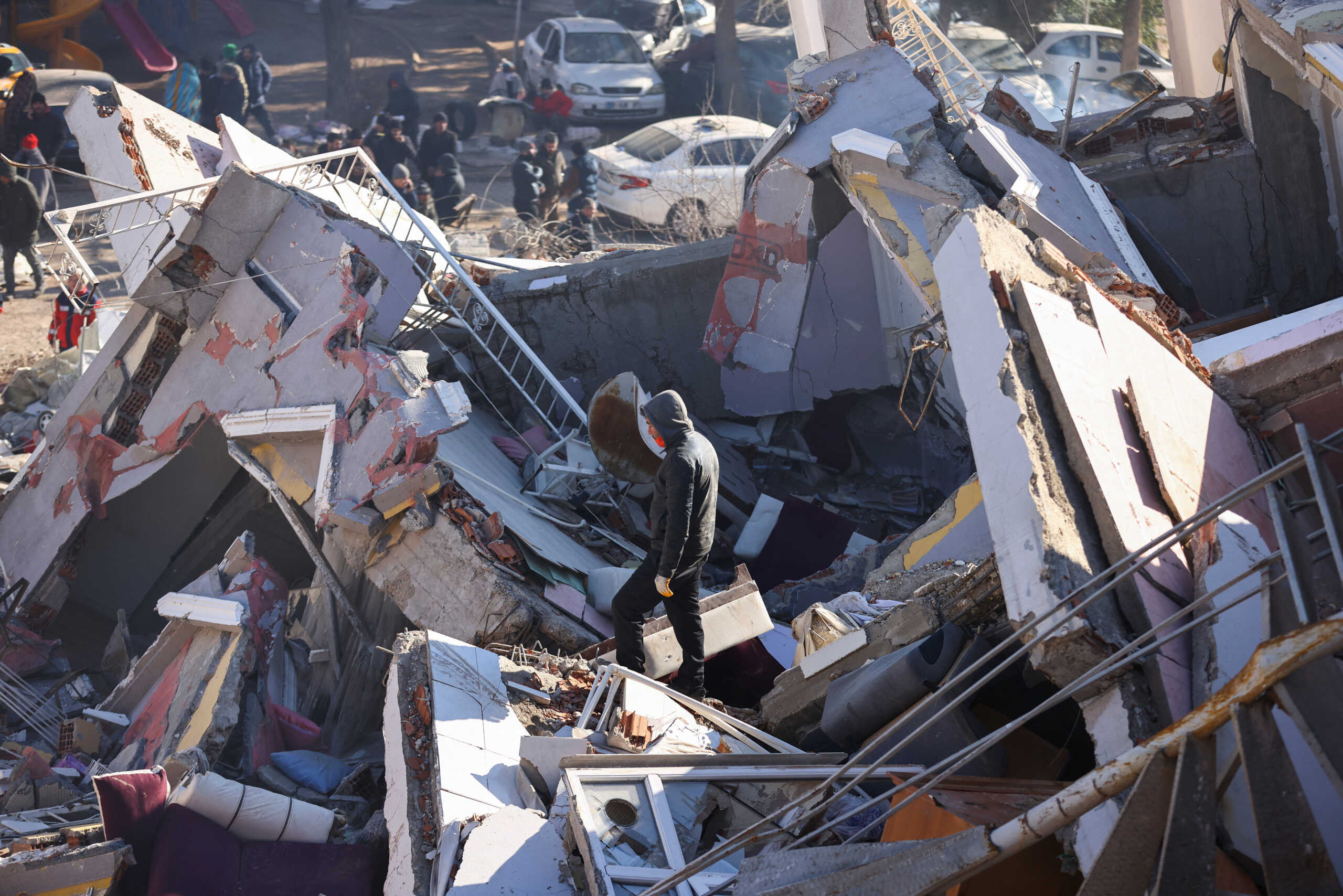 A man stands amid the rubble at the site of a collapsed building, in the aftermath of the deadly earthquake, in Kahramanmaras, Turkey, February 8, 2023. REUTERS