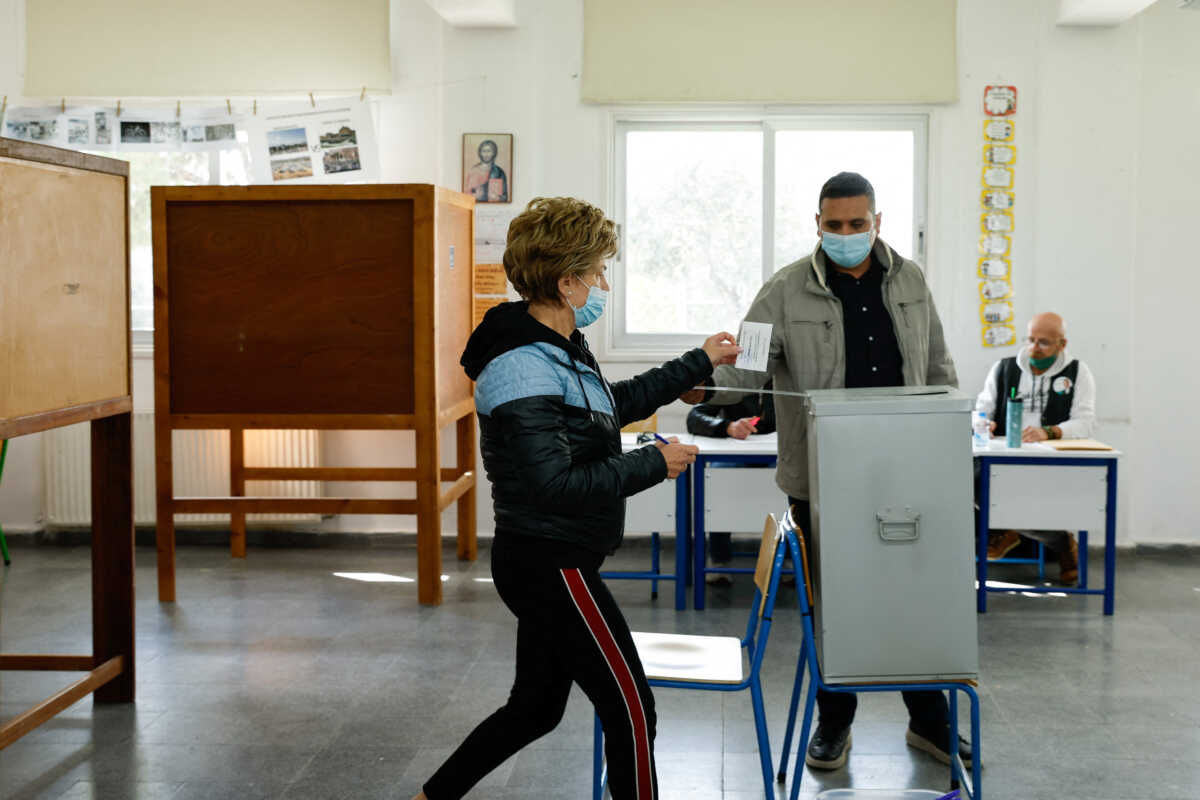 A person votes during the second round of the presidential election at a polling station in Aglatzia near Nicosia, Cyprus, February 12, 2023. REUTERS