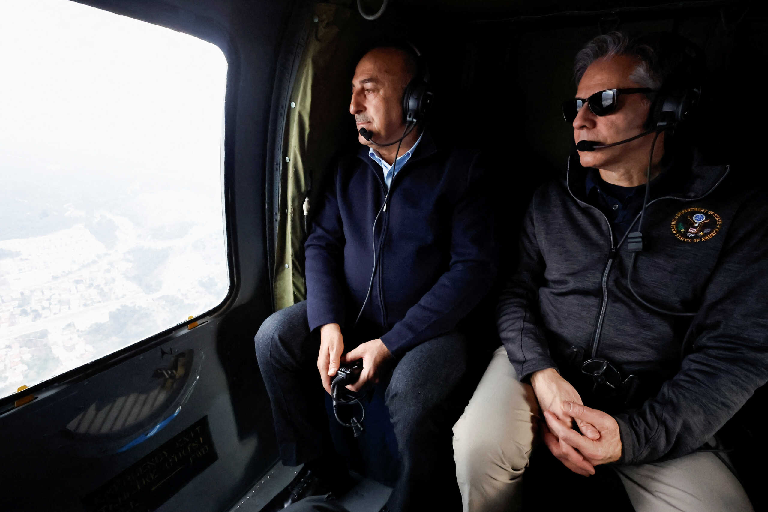 U.S. Secretary of State Antony Blinken and Turkish Foreign Minister Mevlut Cavusoglu sit in a helicopter for a tour of earthquake stricken areas, in Turkey February 19, 2023. REUTERS