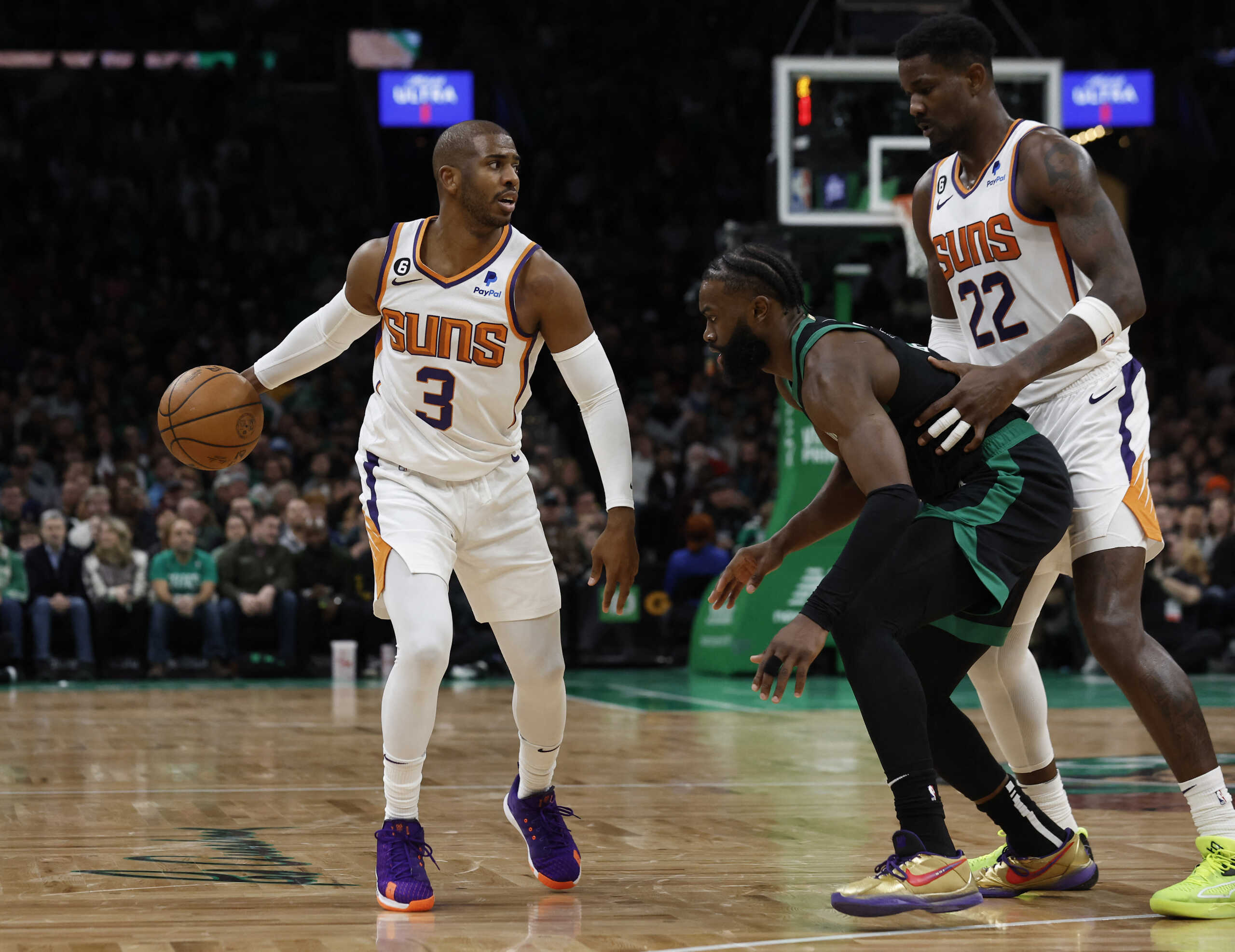 Feb 3, 2023; Boston, Massachusetts, USA; Phoenix Suns guard Chris Paul (3) looks for an opening around Boston Celtics guard Jaylen Brown (7) as center Deandre Ayton (22) looks to set a pick during the second quarter at TD Garden. Mandatory Credit: Winslow Townson-USA TODAY Sports