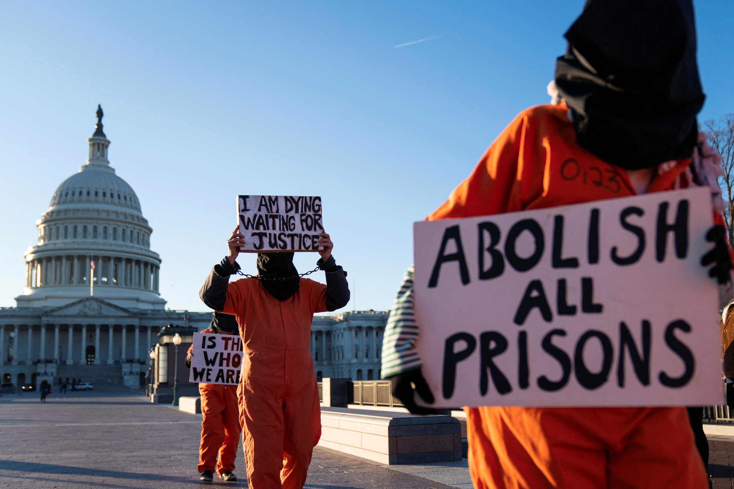A group of people dressed as prisoners protest Guantanamo Bay Detention Camp outside of the U.S. Capitol in Washington, D.C., U.S., January 9, 2023. REUTERS