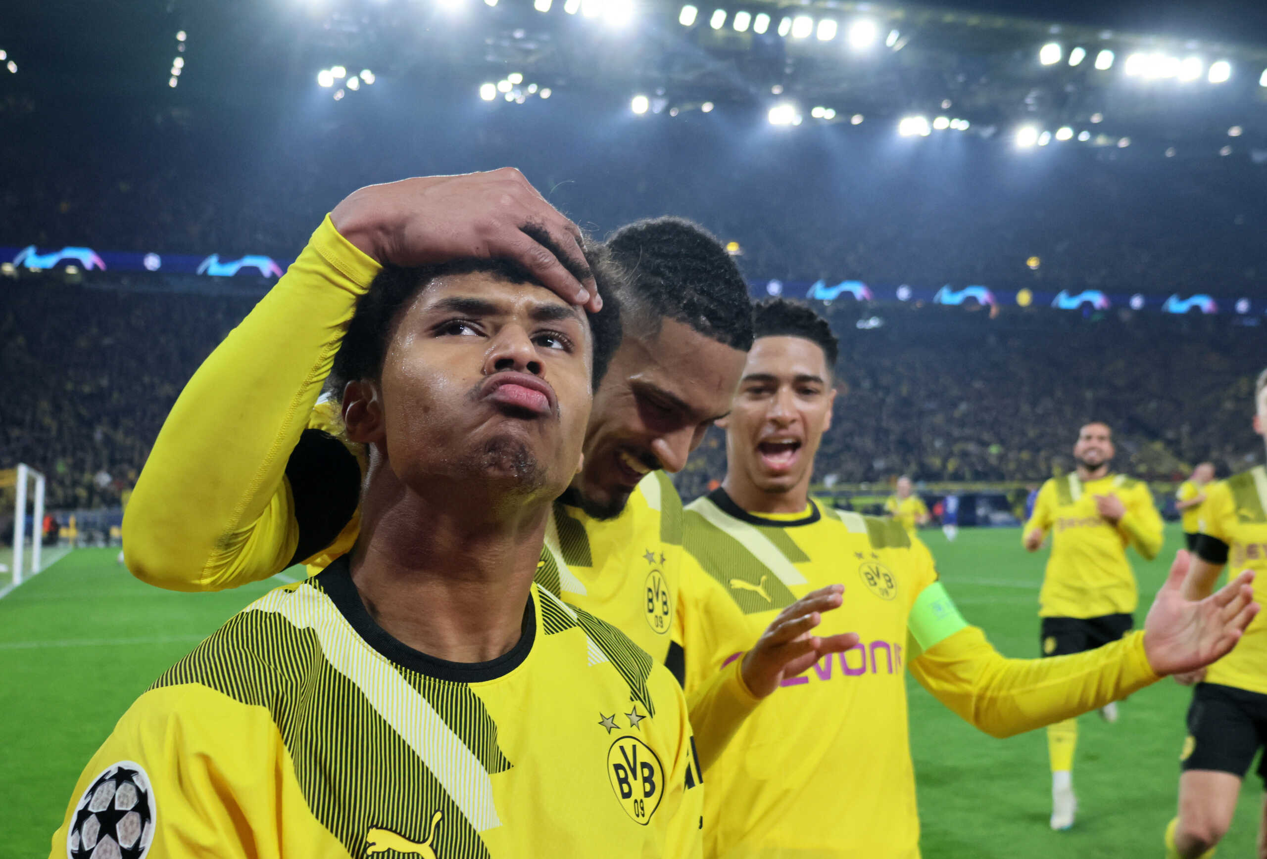 Soccer Football - Champions League - Round of 16 First Leg - Borussia Dortmund v Chelsea - Signal Iduna Park, Dortmund, Germany - February 15, 2023  Borussia Dortmund's Karim Adeyemi celebrates scoring their first goal with Sebastien Haller and Jude Bellingham REUTERS