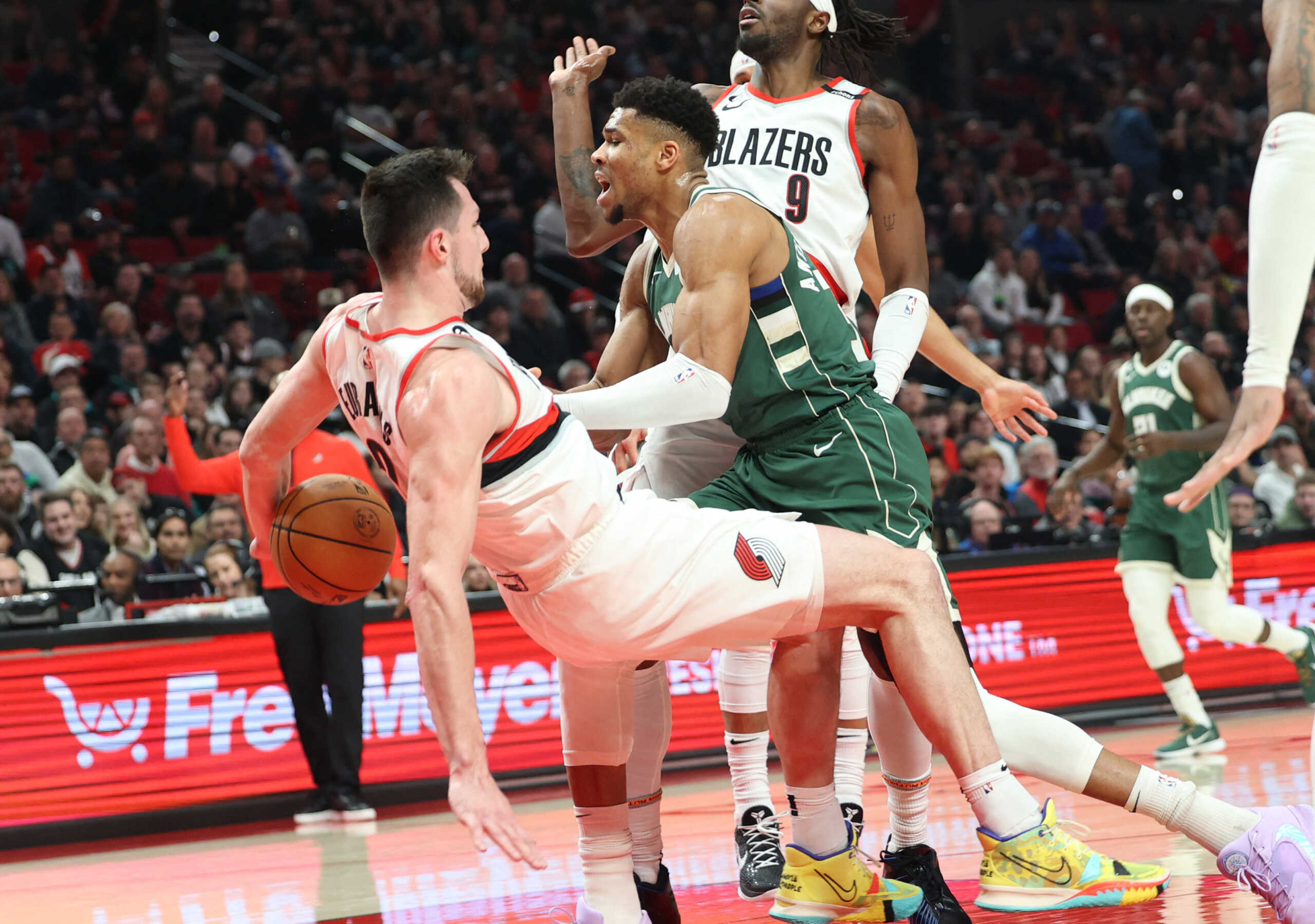 Feb 6, 2023; Portland, Oregon, USA; Portland Trail Blazers forward Drew Eubanks (24) draws an offensive foul on Milwaukee Bucks forward Giannis Antetokounmpo (34) in the first half at Moda Center. Mandatory Credit: Jaime Valdez-USA TODAY Sports
