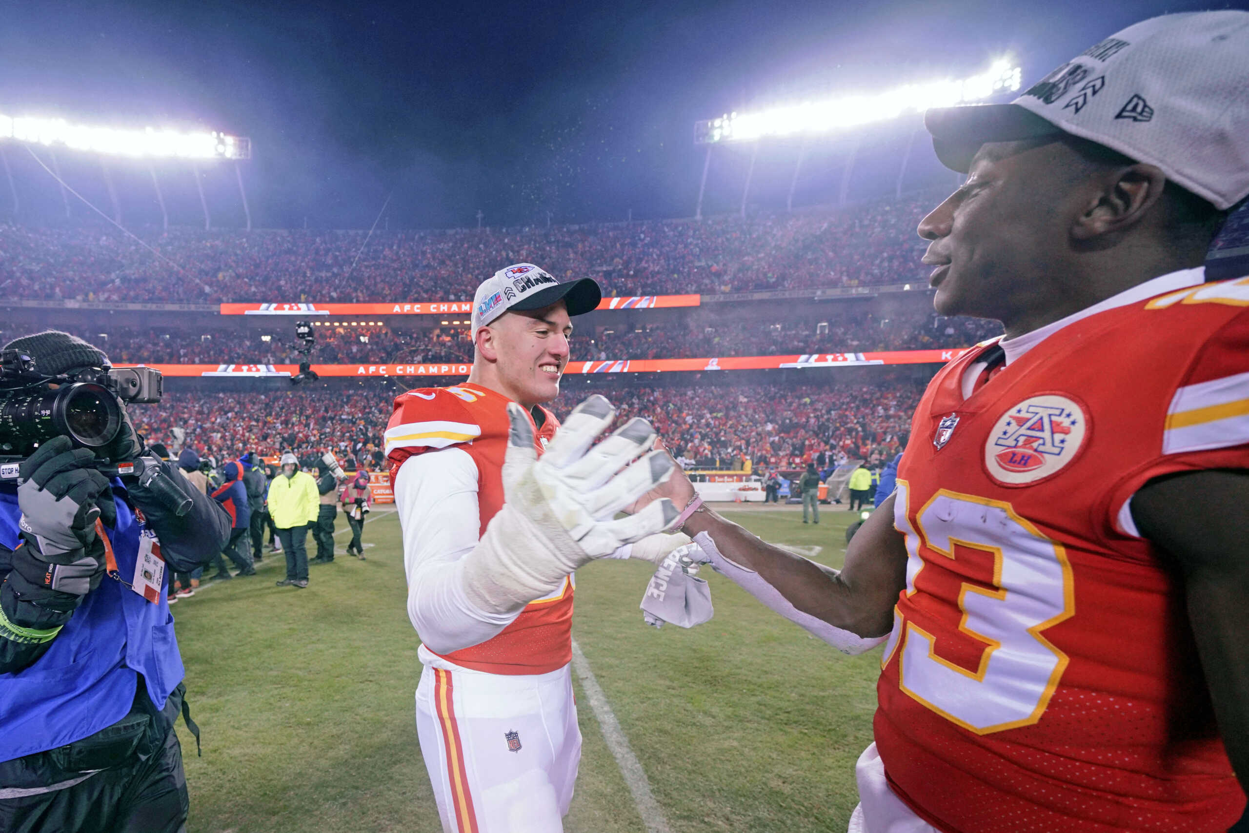 Jan 29, 2023; Kansas City, Missouri, USA; Kansas City Chiefs defensive end George Karlaftis (56) shakes hands with cornerback Joshua Williams (23) after winning the AFC Championship game against the Cincinnati Bengals at GEHA Field at Arrowhead Stadium. Mandatory Credit: Denny Medley-USA TODAY Sports