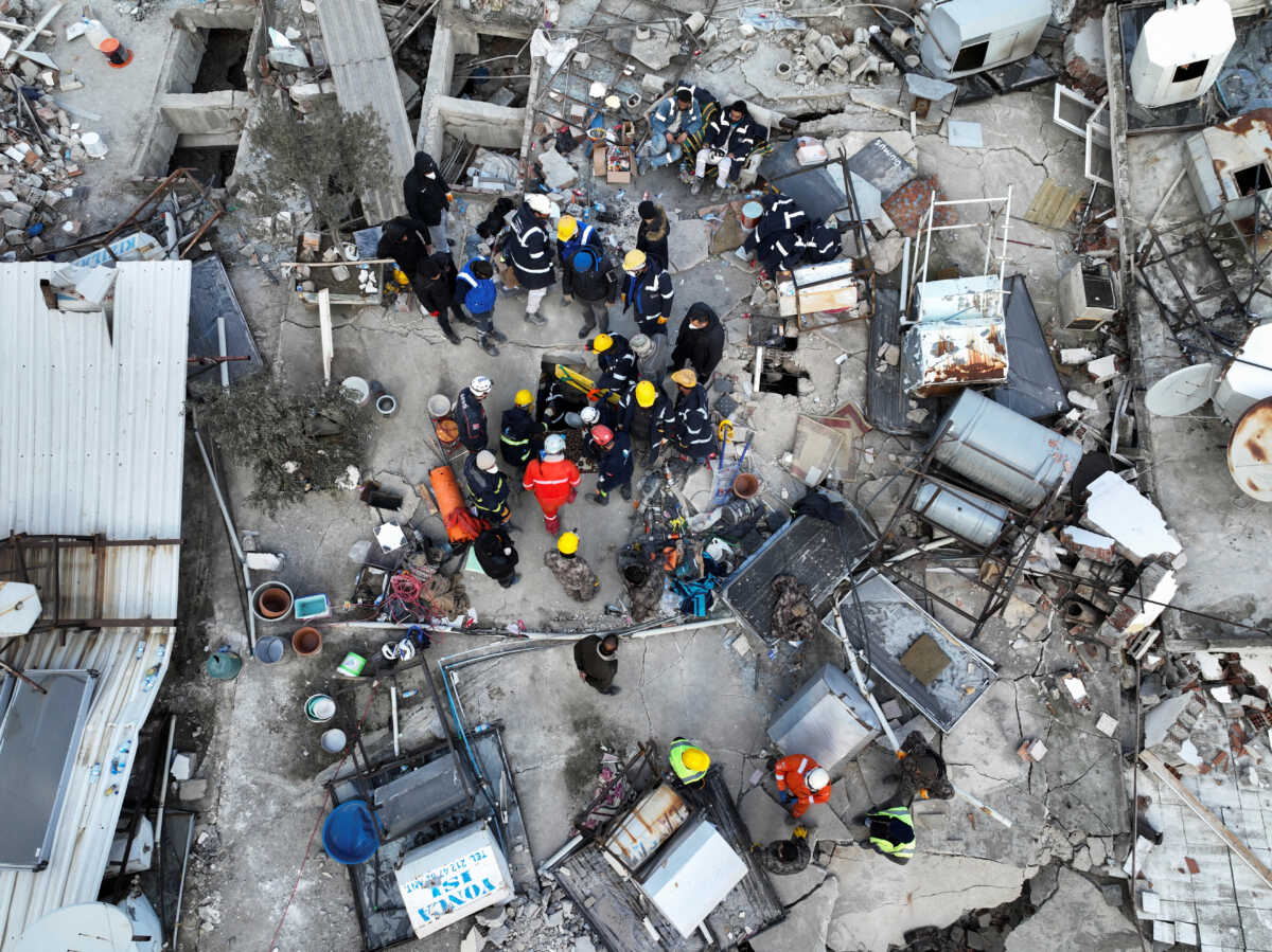 Rescuers try to free a child trapped under the rubble, following the deadly earthquake in Hatay, Turkey, February 10, 2023. REUTERS