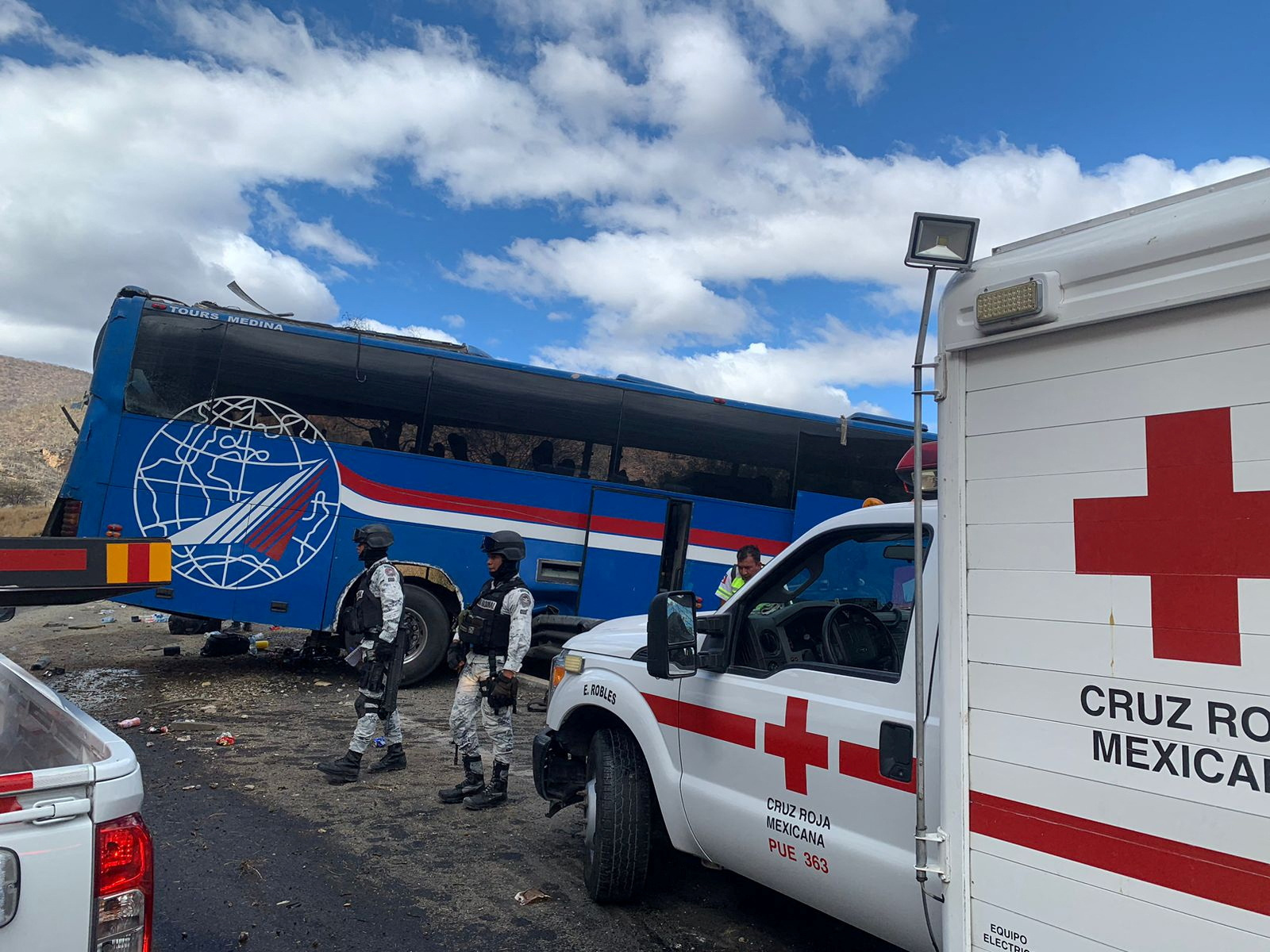 Members of the National Guard stand at the scene of a bus accident which was carrying migrants from Venezuela, Colombia and Central America, in Cuacnopalan, Mexico February 19, 2023. Cruz Roja Puebla