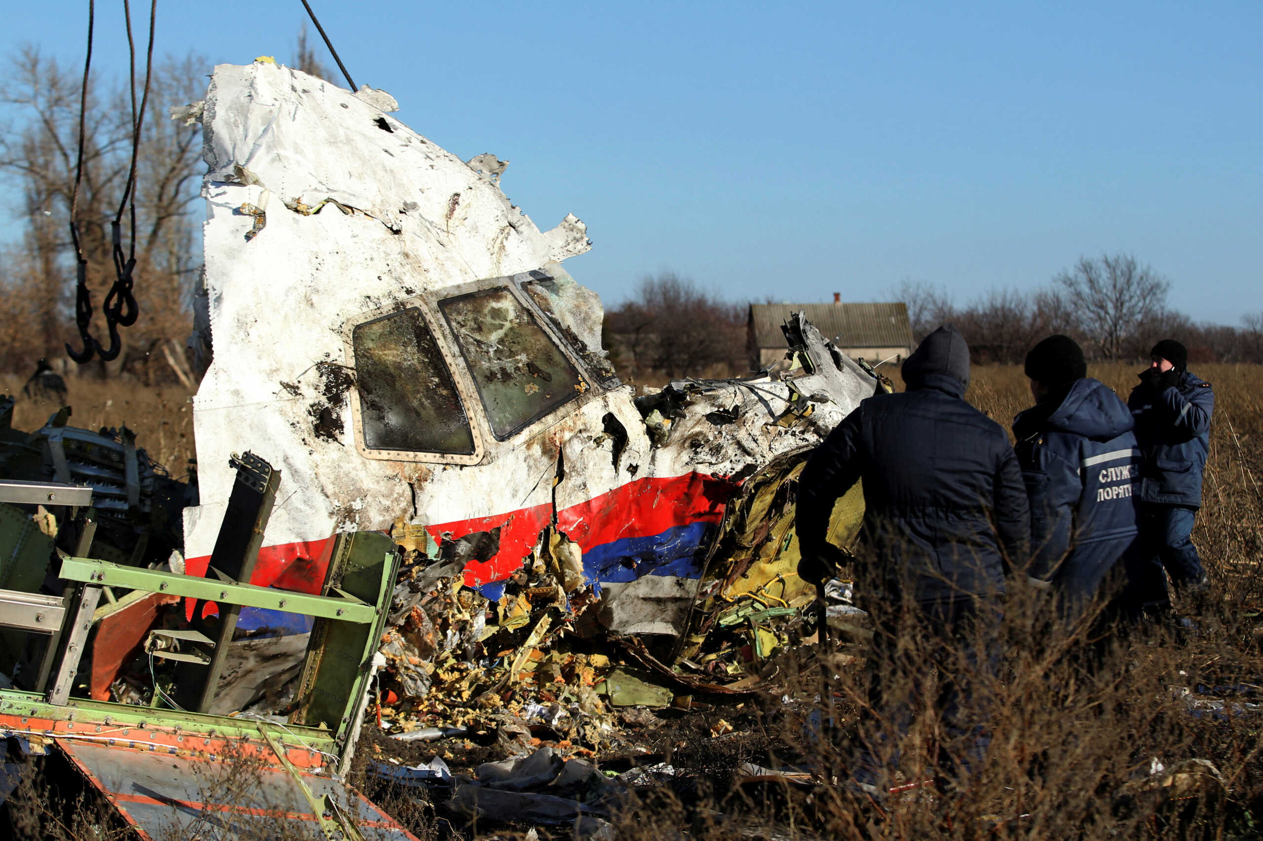 FILE PHOTO: Local workers transport a piece of wreckage from Malaysia Airlines flight MH17 at the site of the plane crash near the village of Hrabove (Grabovo) in Donetsk region, eastern Ukraine November 20, 2014. REUTERS