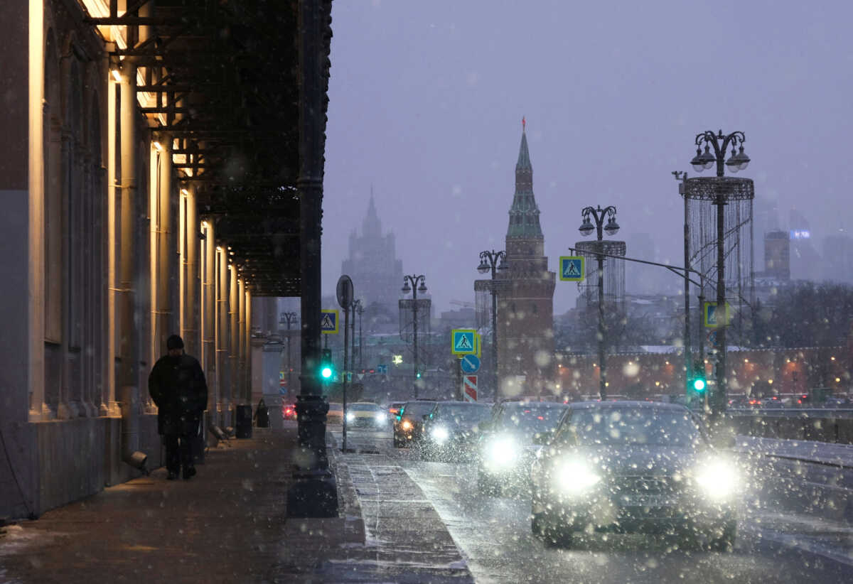 Cars drive along the embankment of the Moskva River during a snowfall in Moscow, Russia February 16, 2023. REUTERS