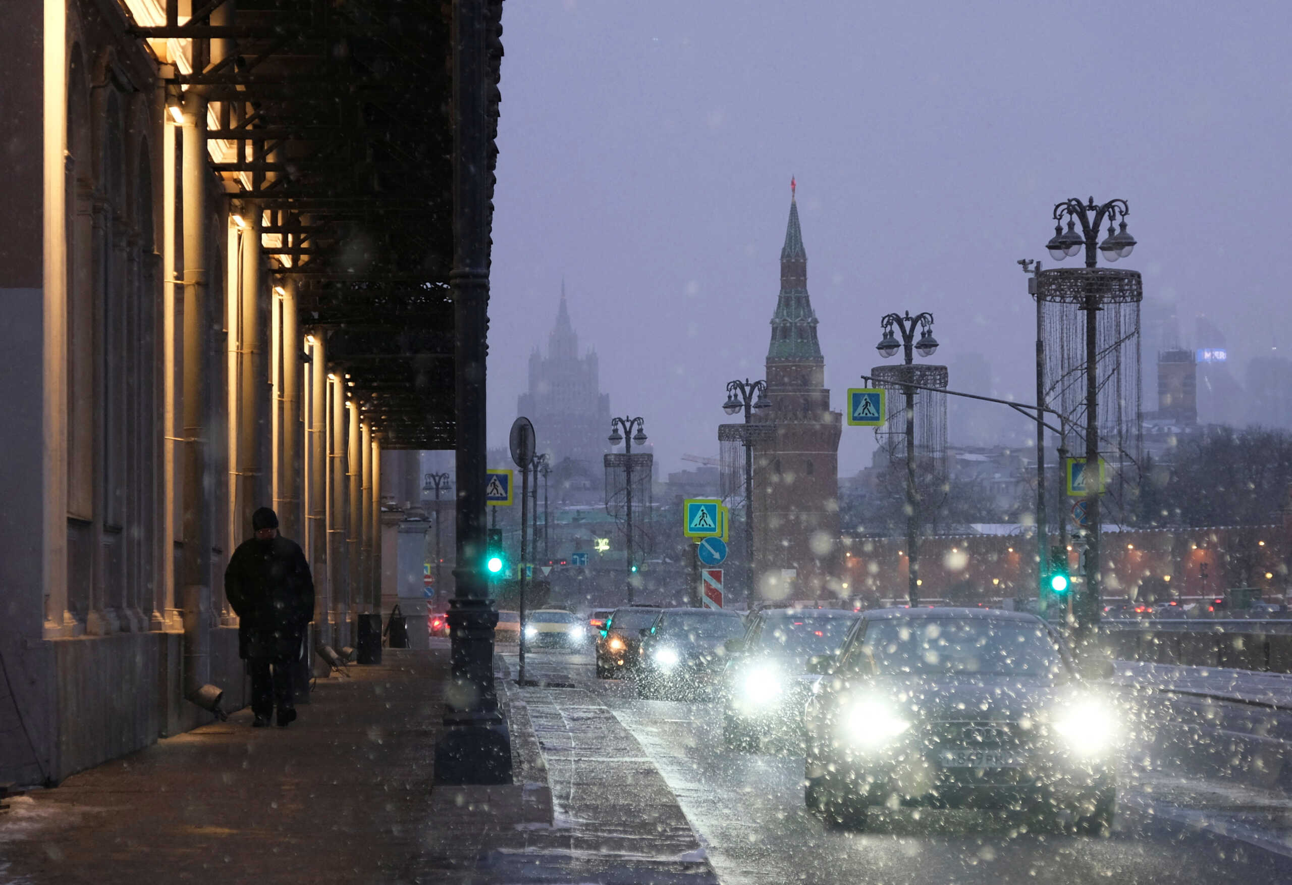 Cars drive along the embankment of the Moskva River during a snowfall in Moscow, Russia February 16, 2023. REUTERS