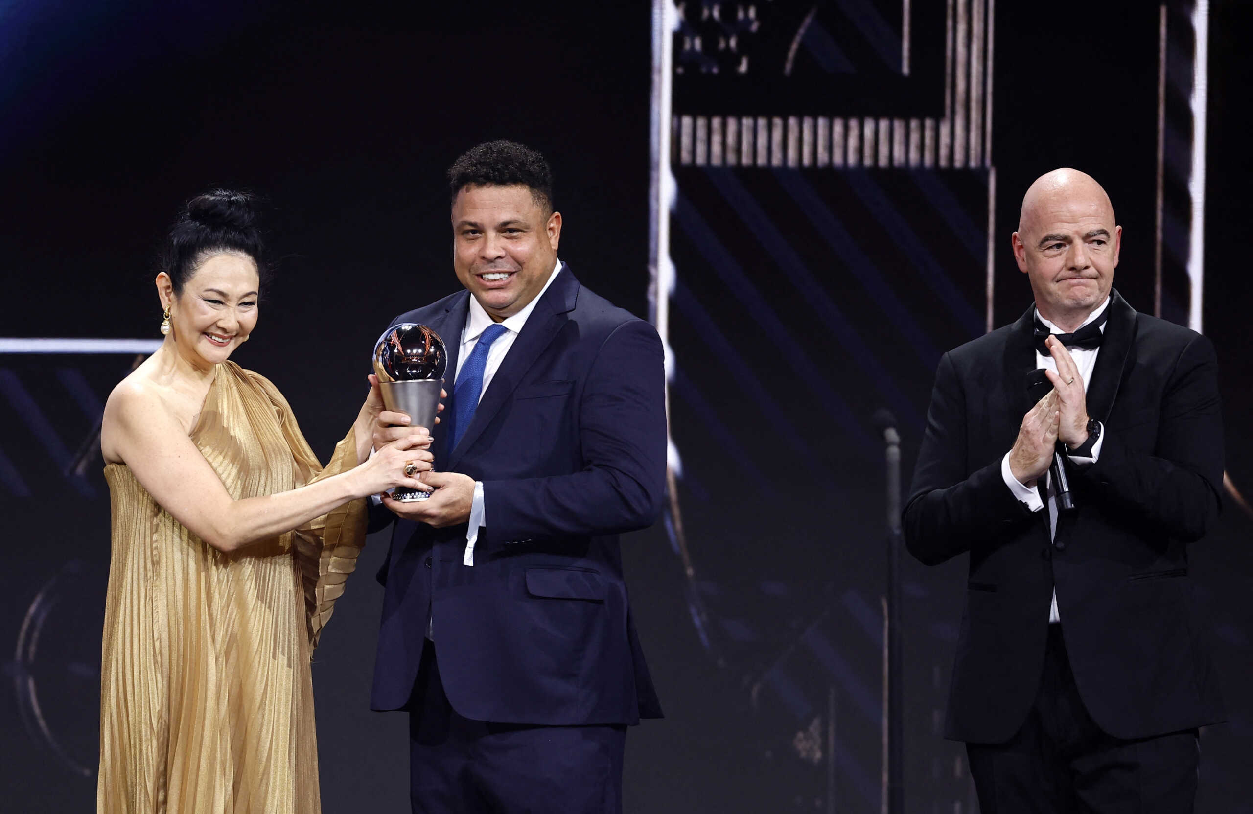 Soccer Football - The Best FIFA Football Awards - Salle Pleyel, Paris, France - February 27, 2023 Pele's widow Marcia Aoki receives a Pele tribute trophy from Ronaldo and FIFA president Gianni Infantino during the Best FIFA Football Awards REUTERS