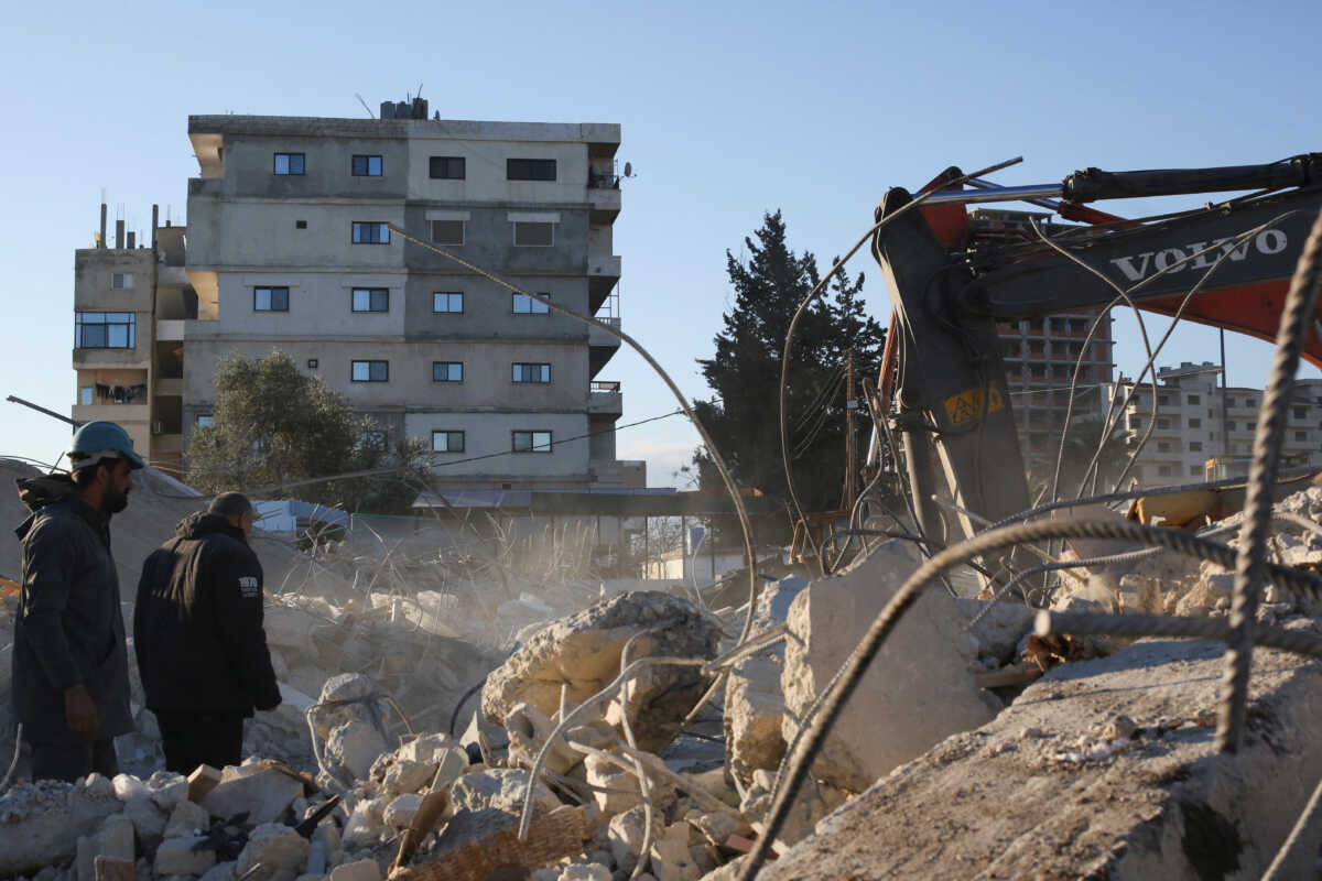 Rescuers work at the site of a collapsed building, in the aftermath of an earthquake, in Latakia, Syria February 9, 2023. REUTERS