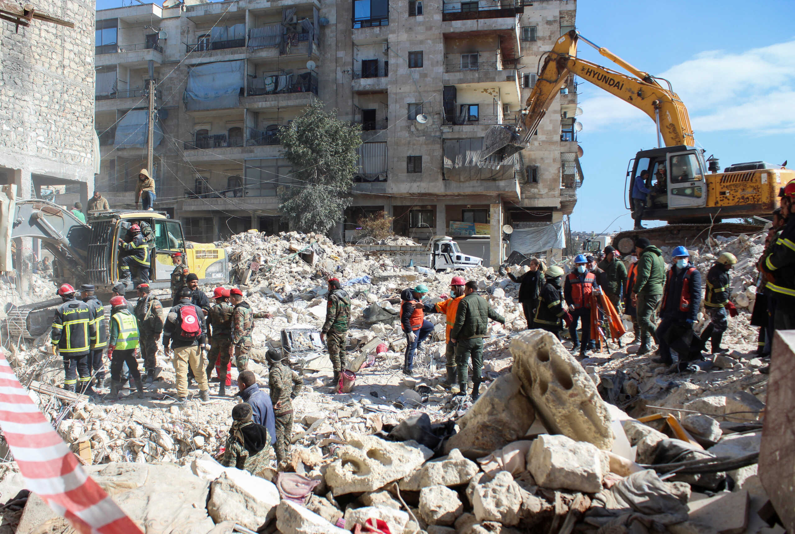 Members of the Algerian rescue team and Syrian army soldiers search for survivors at the site of a damaged building, in the aftermath of the earthquake in Aleppo, Syria February 8, 2023. REUTERS
