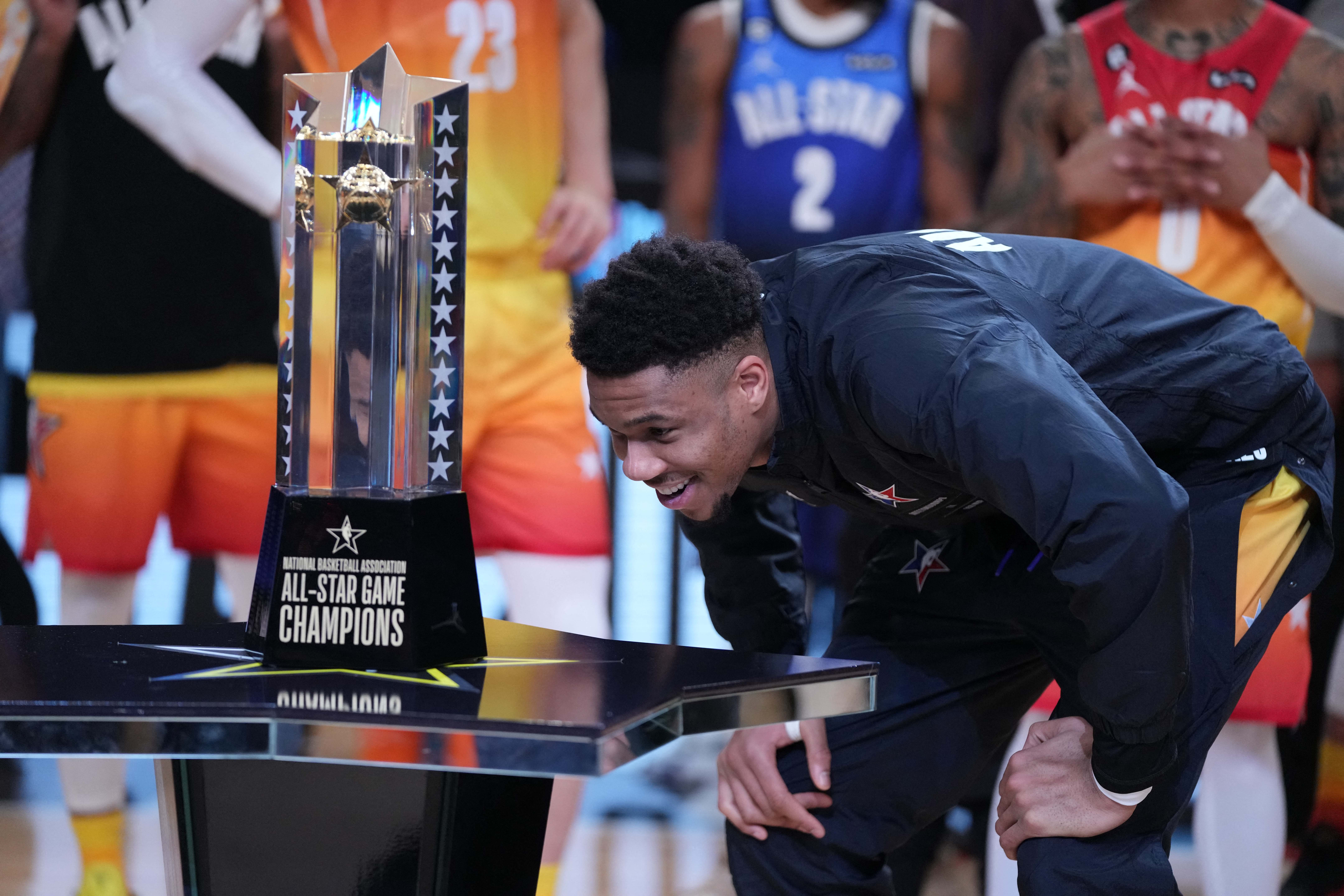 Feb 19, 2023; Salt Lake City, UT, USA; Team Giannis forward Giannis Antetokounmpo (34) looks at the NBA All-Star Game Trophy after the 2023 NBA All-Star Game at Vivint Arena. Mandatory Credit: Kyle Terada-USA TODAY Sports